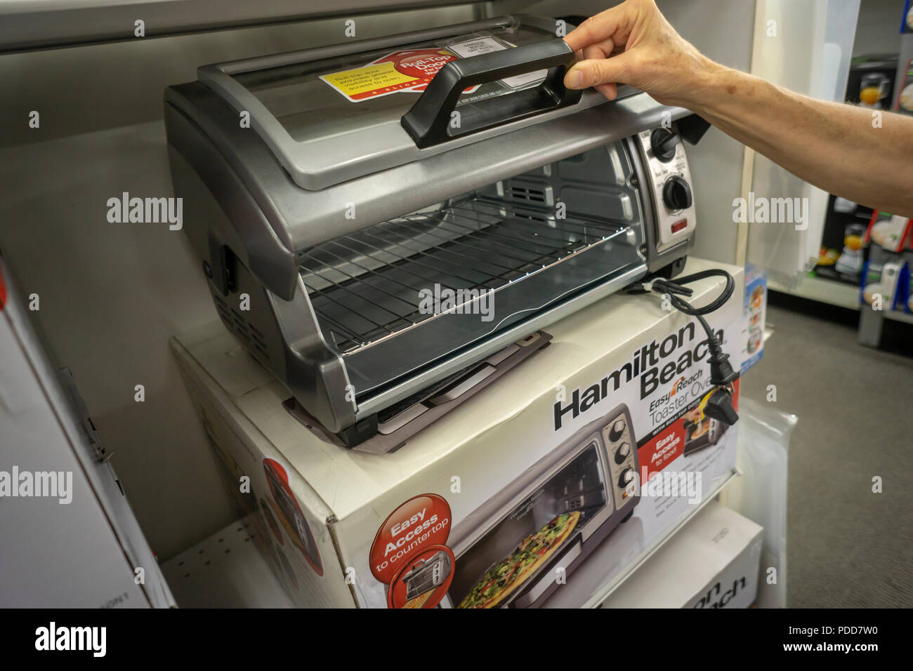 A shopper chooses a Hamilton Beach brand toaster oven in a home goods store in New York on Wednesday, August 1, 2018. Hamilton Beach is scheduled to report quarterly earnings on August 2 prior to the bell.  (© Richard B. Levine) Stock Photo