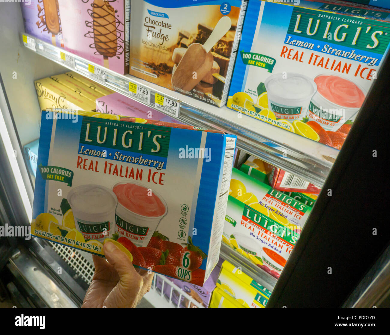 A shopper in a supermarket in New York chooses a package of Luigi's Italian Ices, a brand of J&J Snack Foods on Monday, July 30, 2018. J&J Snack Foods recently reported fiscal third-quarter profits that beat analysts' expectations. The company has reported net sales that increased every quarter for 46 years.  (Â© Richard B. Levine) Stock Photo