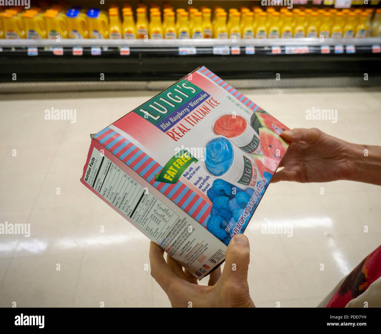 A shopper in a supermarket in New York chooses a package of Luigi's Italian Ices, a brand of J&J Snack Foods on Monday, July 30, 2018. J&J Snack Foods recently reported fiscal third-quarter profits that beat analysts' expectations. The company has reported net sales that increased every quarter for 46 years.  (© Richard B. Levine) Stock Photo