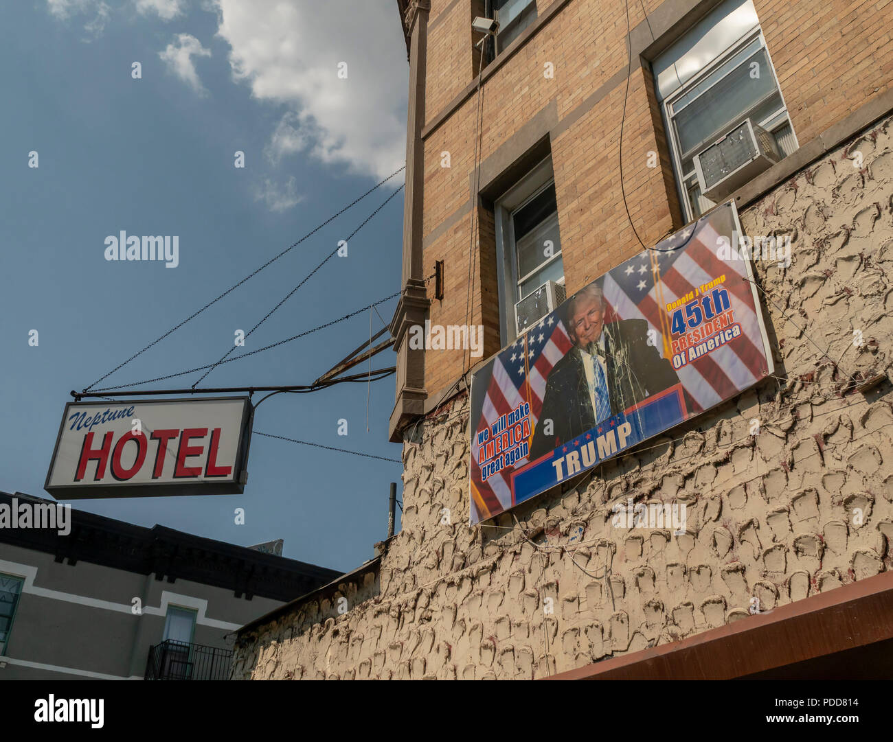 Pro-Trump sign on the side of the Neptune Hotel on Broadway under the elevated line in the Bushwick neighborhood of Brooklyn in New York on Sunday, August 5, 2018. As more and more hipsters move into the neighborhood the ethnicity of the area is changing.  (Â© Richard B. Levine) Stock Photo