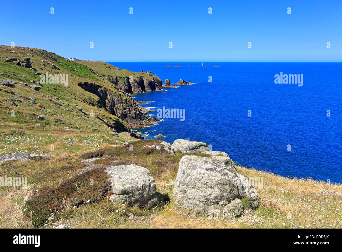 Distant Longships Lighthouse off Land's End from Maen Cliff Castle on the South West Coast Path, Sennen, Cornwall, England, UK. Stock Photo