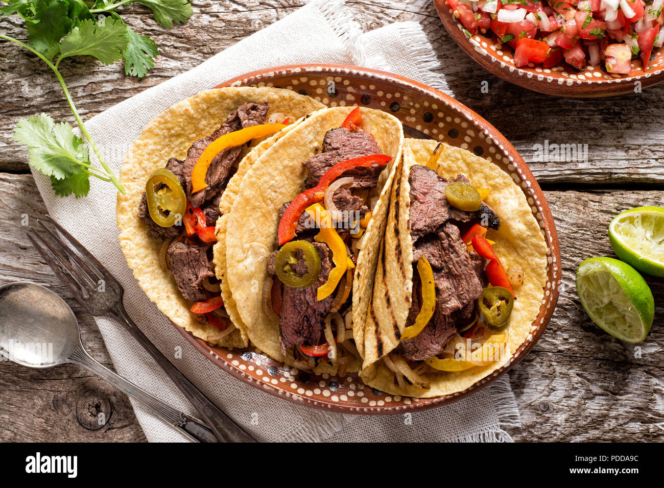 Delicious grilled beef fajitas with steak, onion, bell peppers and