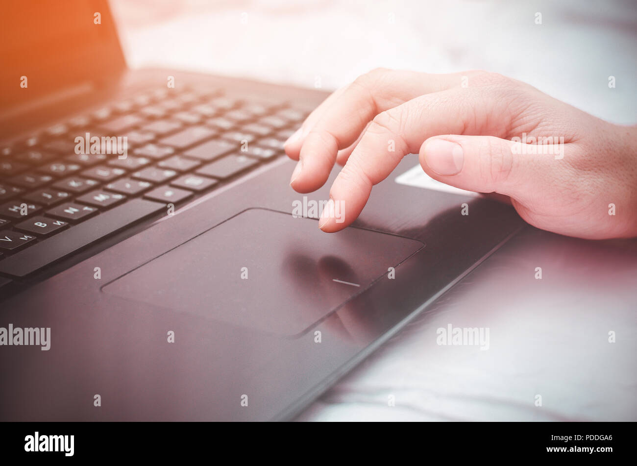 female hand on a laptop, touchpad. work at the computer. notebooks Stock Photo