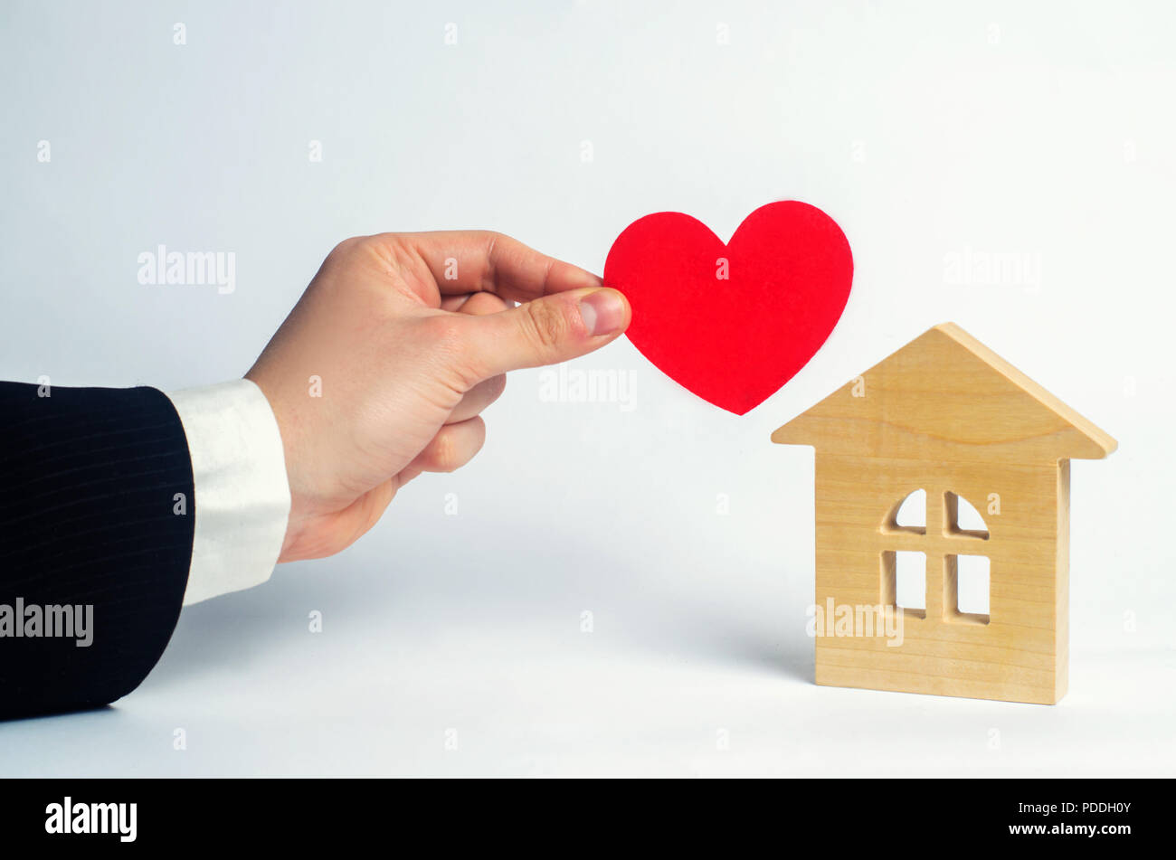 The man's hand holds the heart and the house . House of lovers