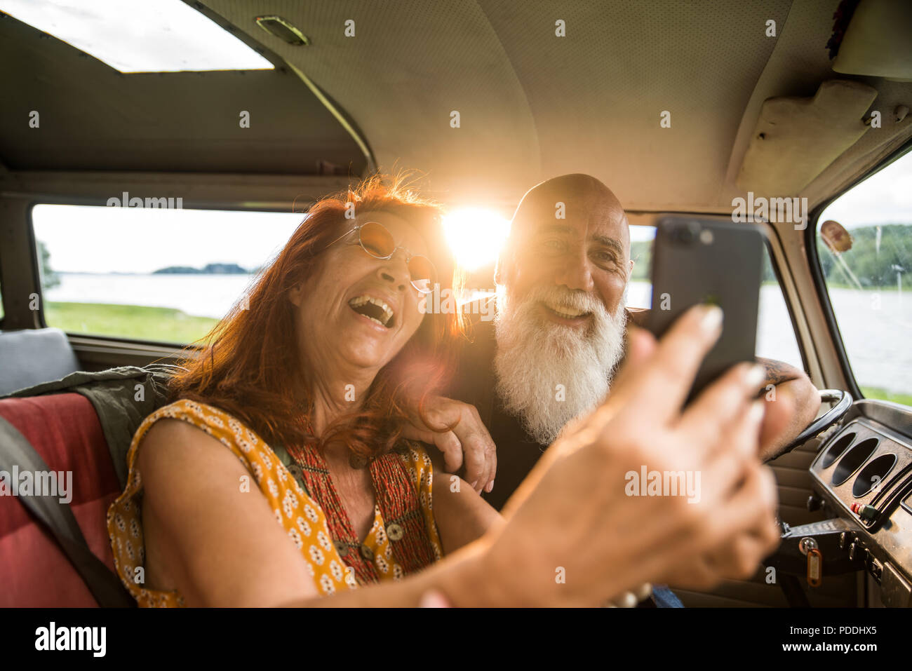 Portrait of an old hipster couple doing a selfie with a phone  Stock Photo