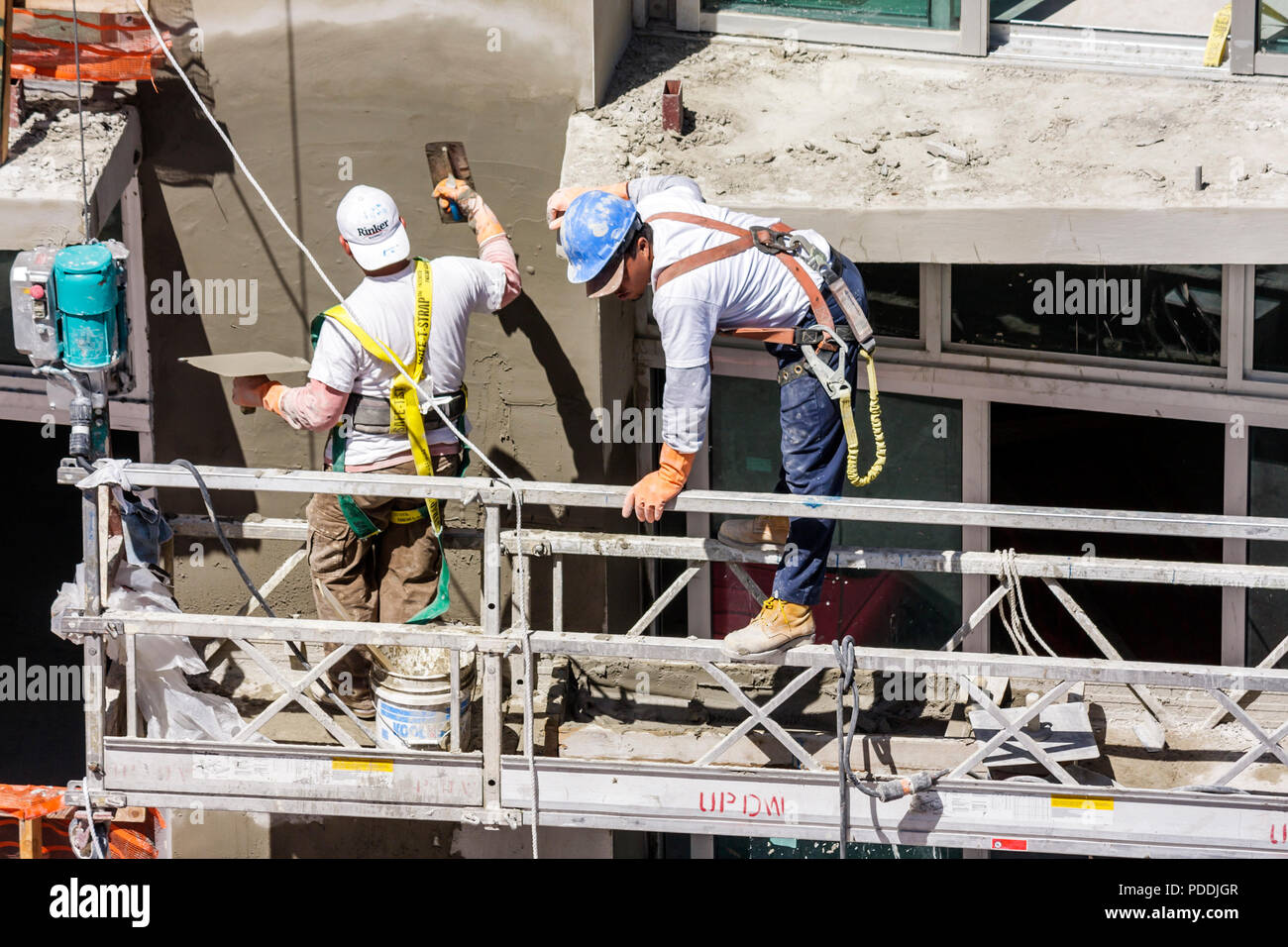 Miami Beach Florida,Ocean Drive,man men male,laborer,under new construction site building builder,worker,workers,builder,helmet,scaffold,working,work, Stock Photo