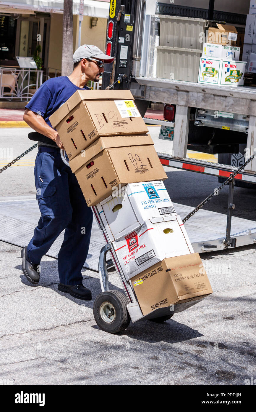 Miami Beach Florida,Ocean Drive,Hispanic man men male,worker,workers,laborer,hand truck cart,dolly,boxes,load,transport,deliver,truck,lorry,working,wo Stock Photo