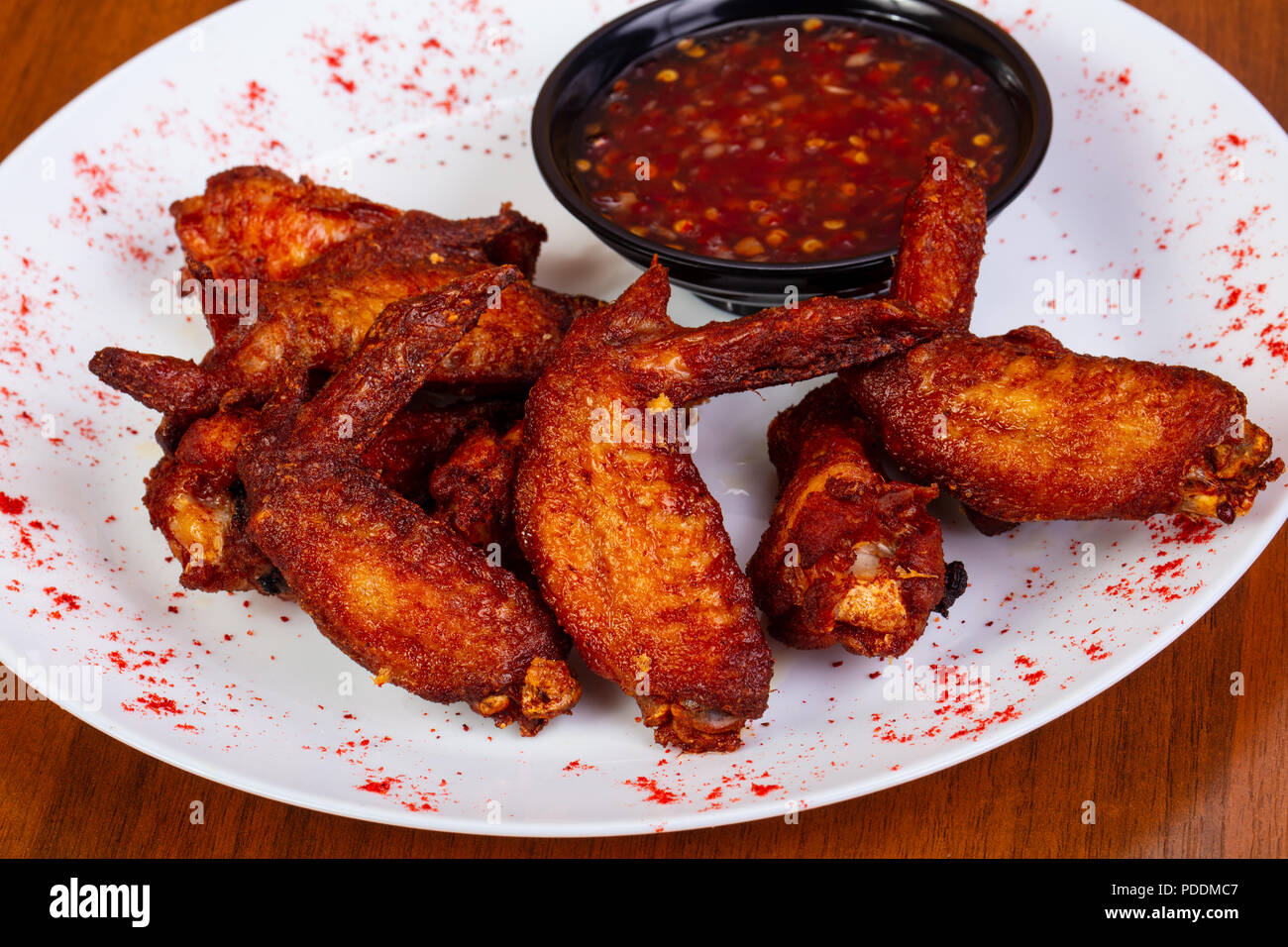Spicy chicken wings with sauce Stock Photo - Alamy