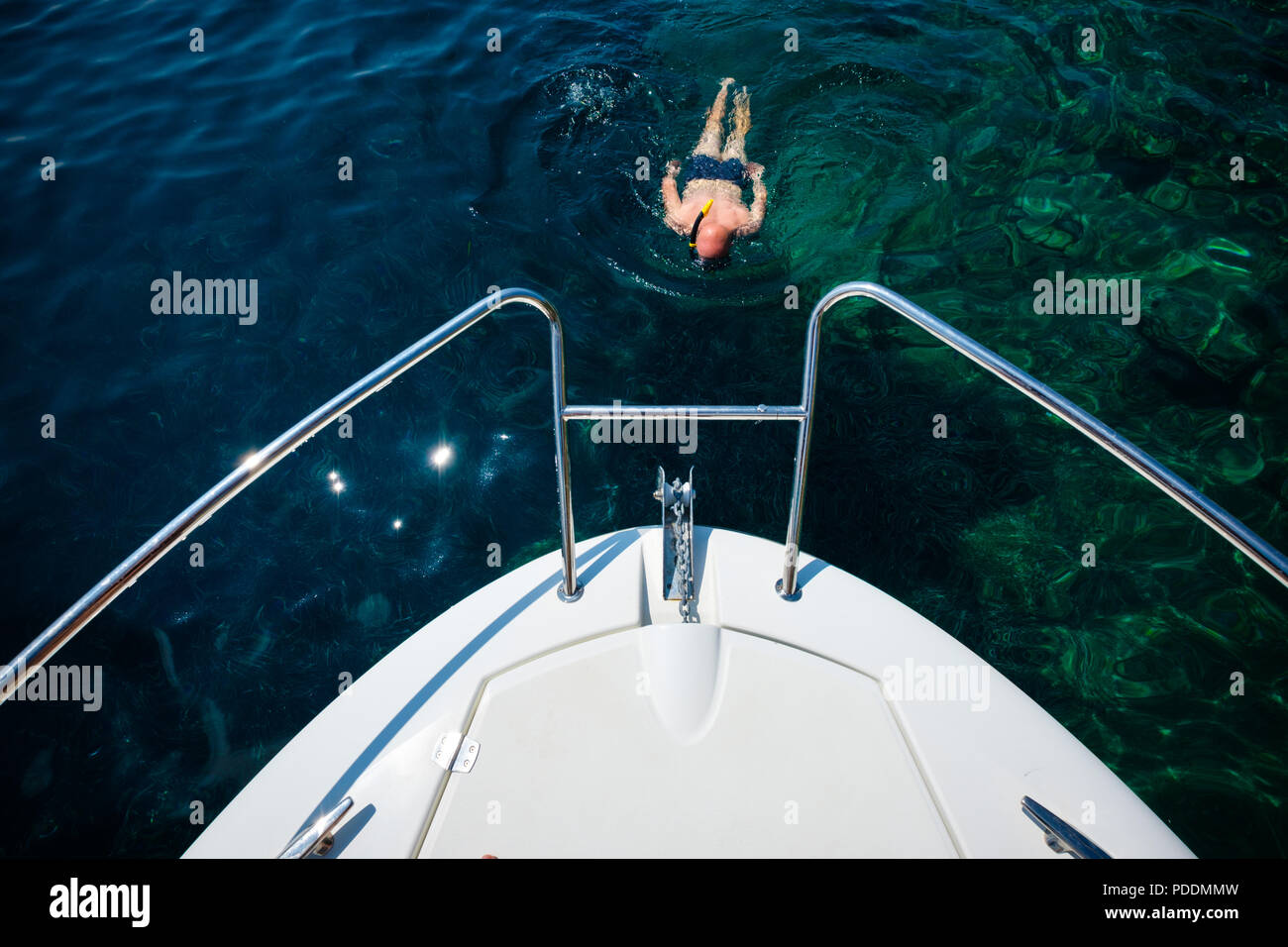 Man snorkeling near a yacht Stock Photo