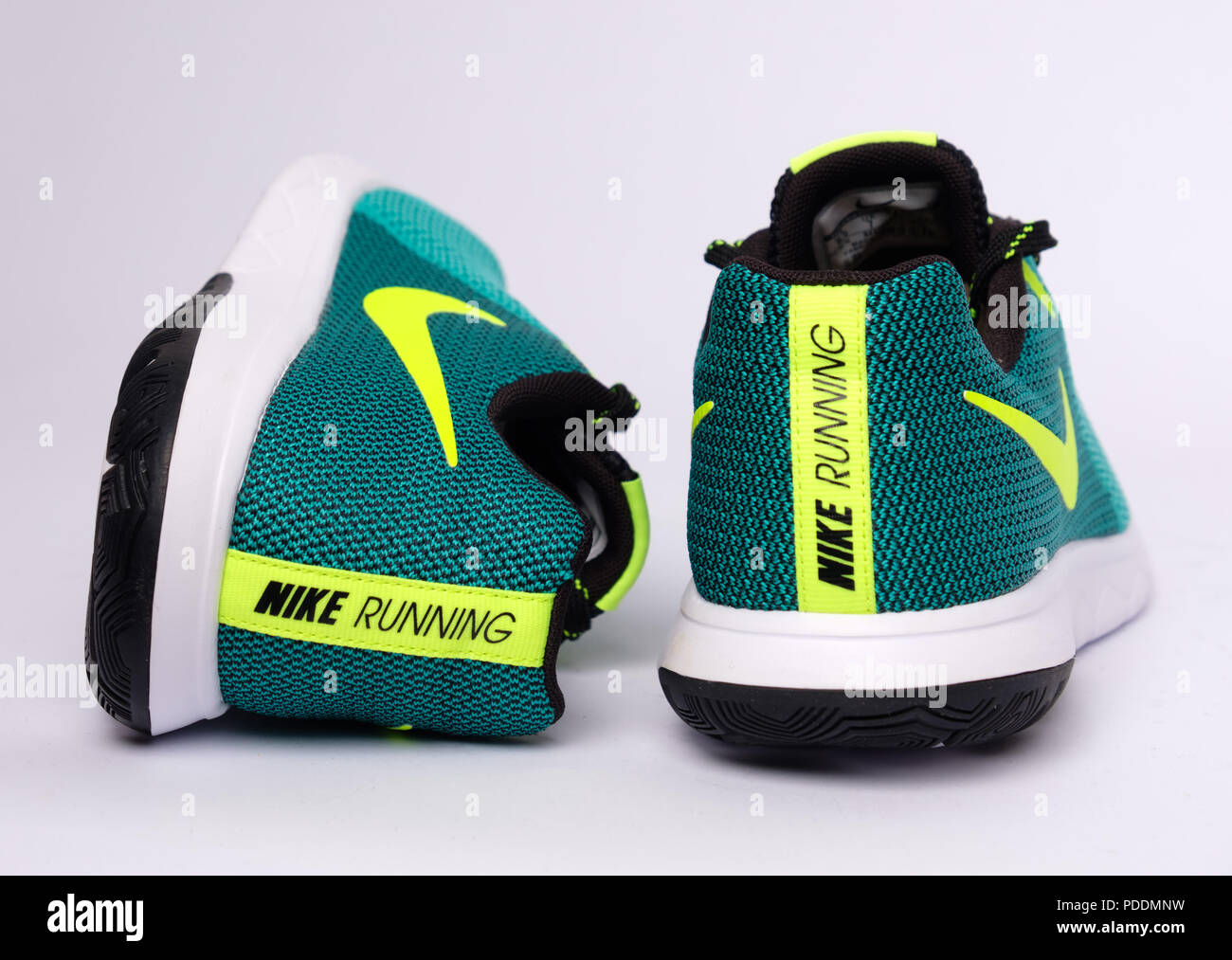 Pair of green Nike Flex Experience RN 5 running shoes cut out isolated on  white background Stock Photo - Alamy