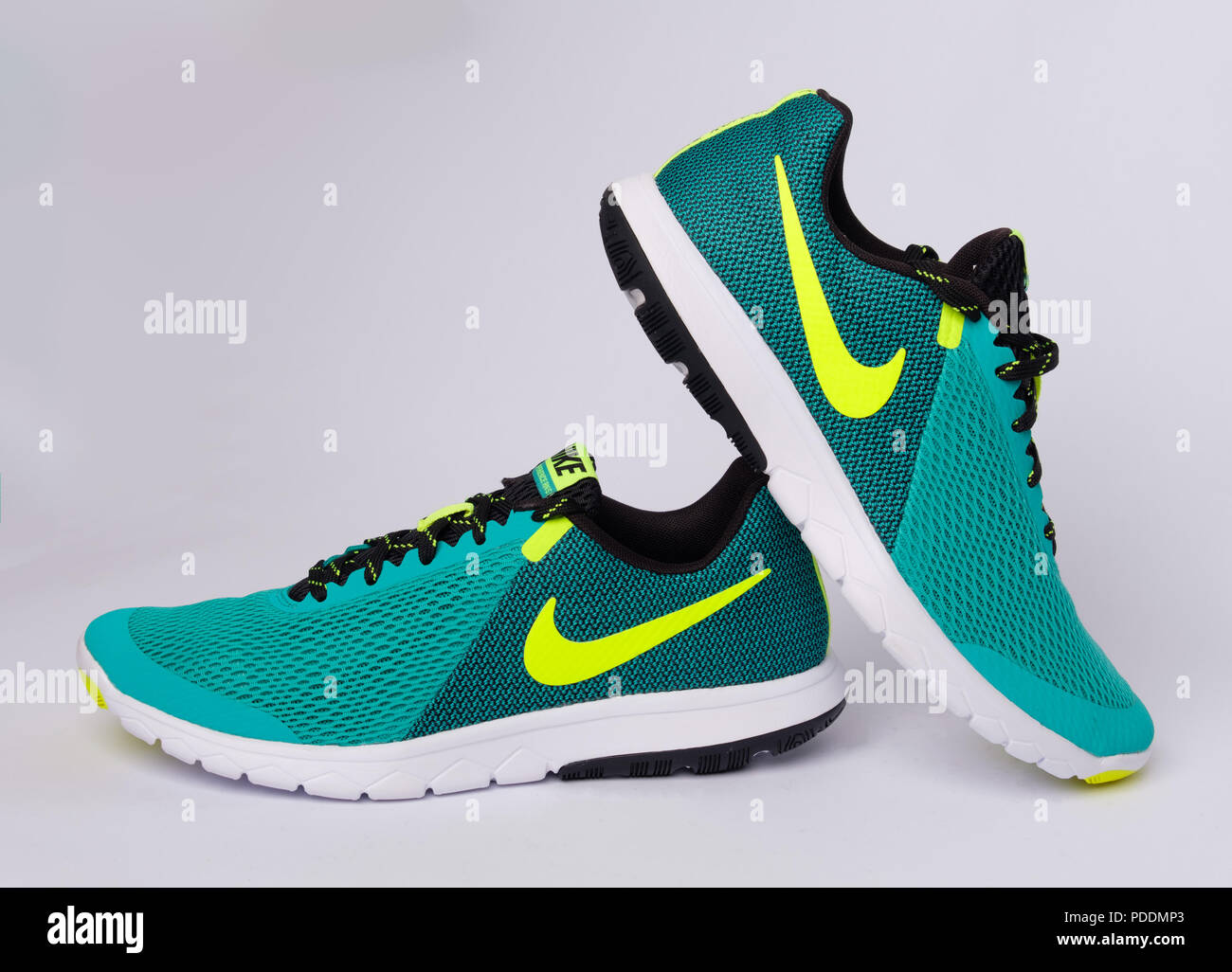 Pair of green Nike Flex Experience RN 5 running shoes cut out isolated on  white background Stock Photo - Alamy