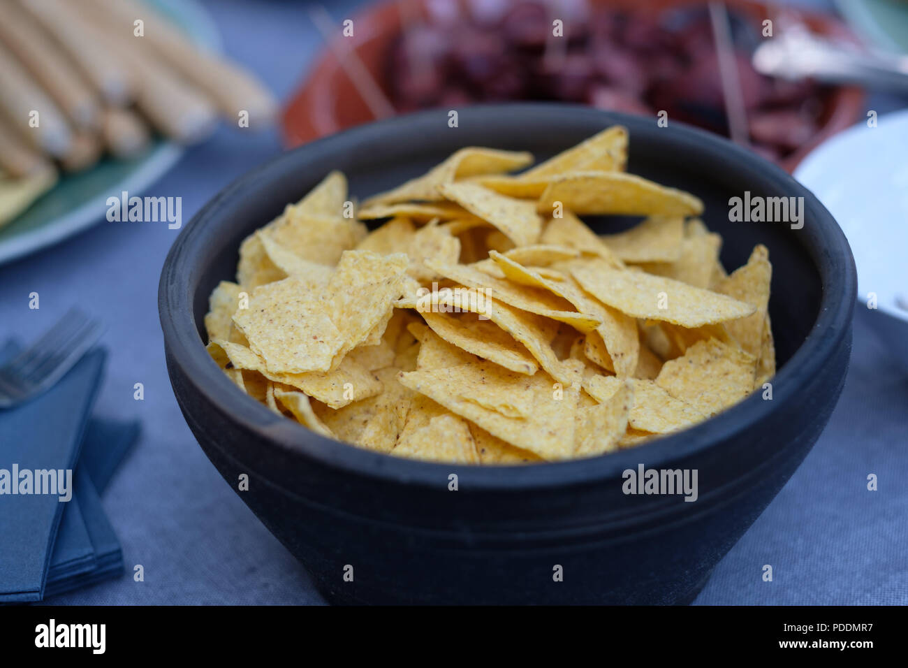 Close up of a bowl of nachos (mexican chips) on a table Stock Photo