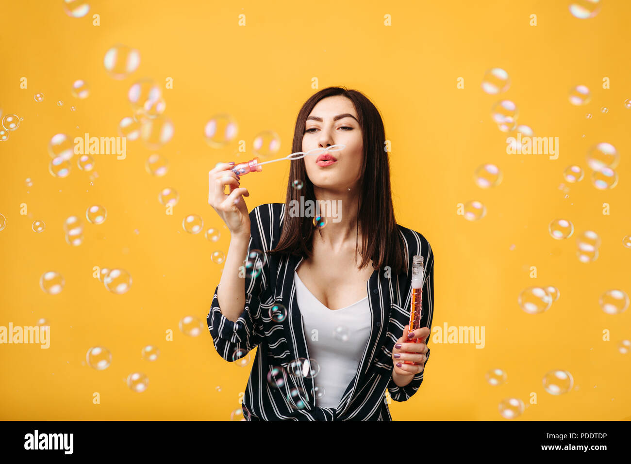 Woman with soap bubbles, yellow background Stock Photo - Alamy