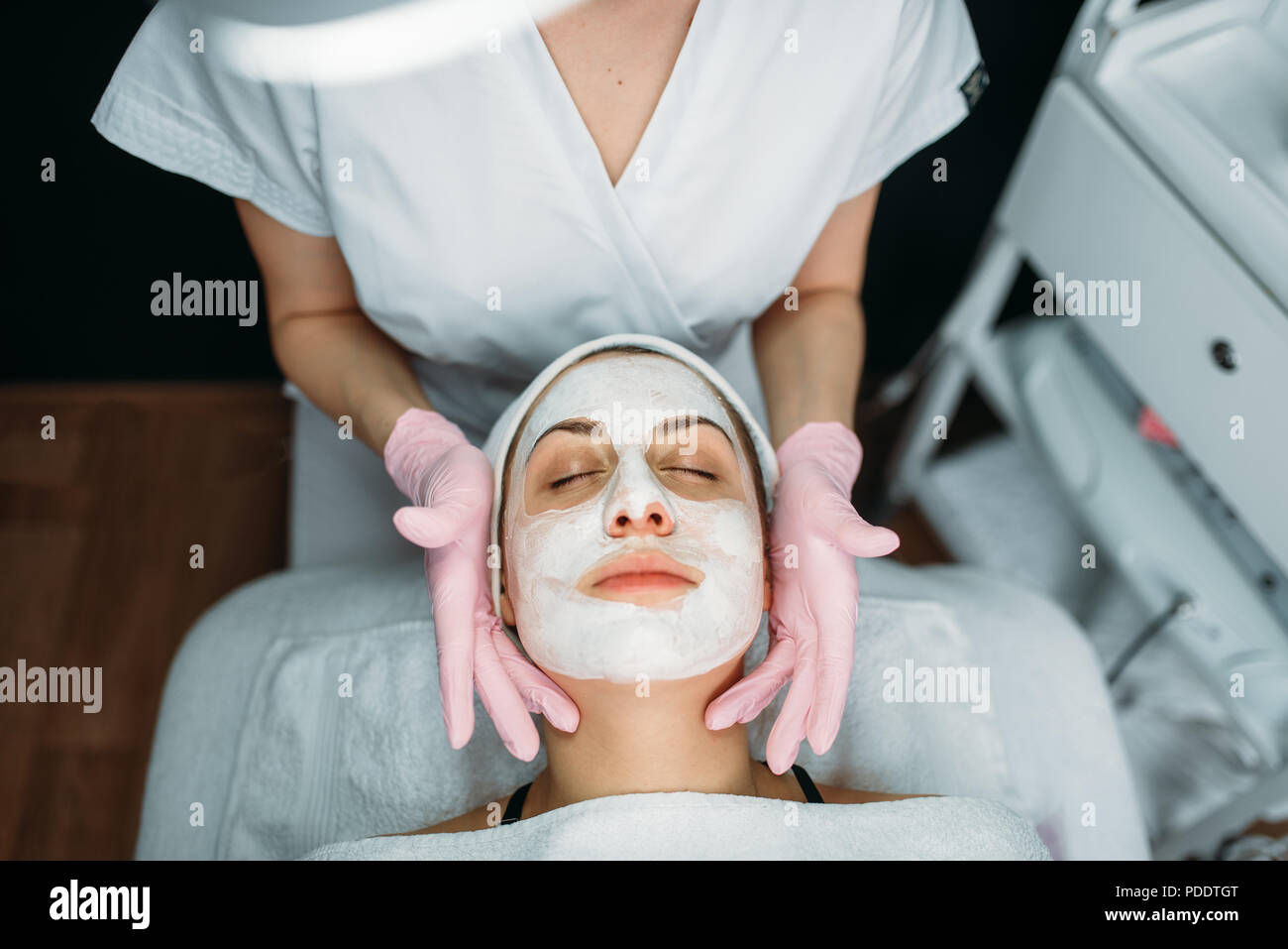 Doctor makes face mask with cream, female patient Stock Photo Alamy