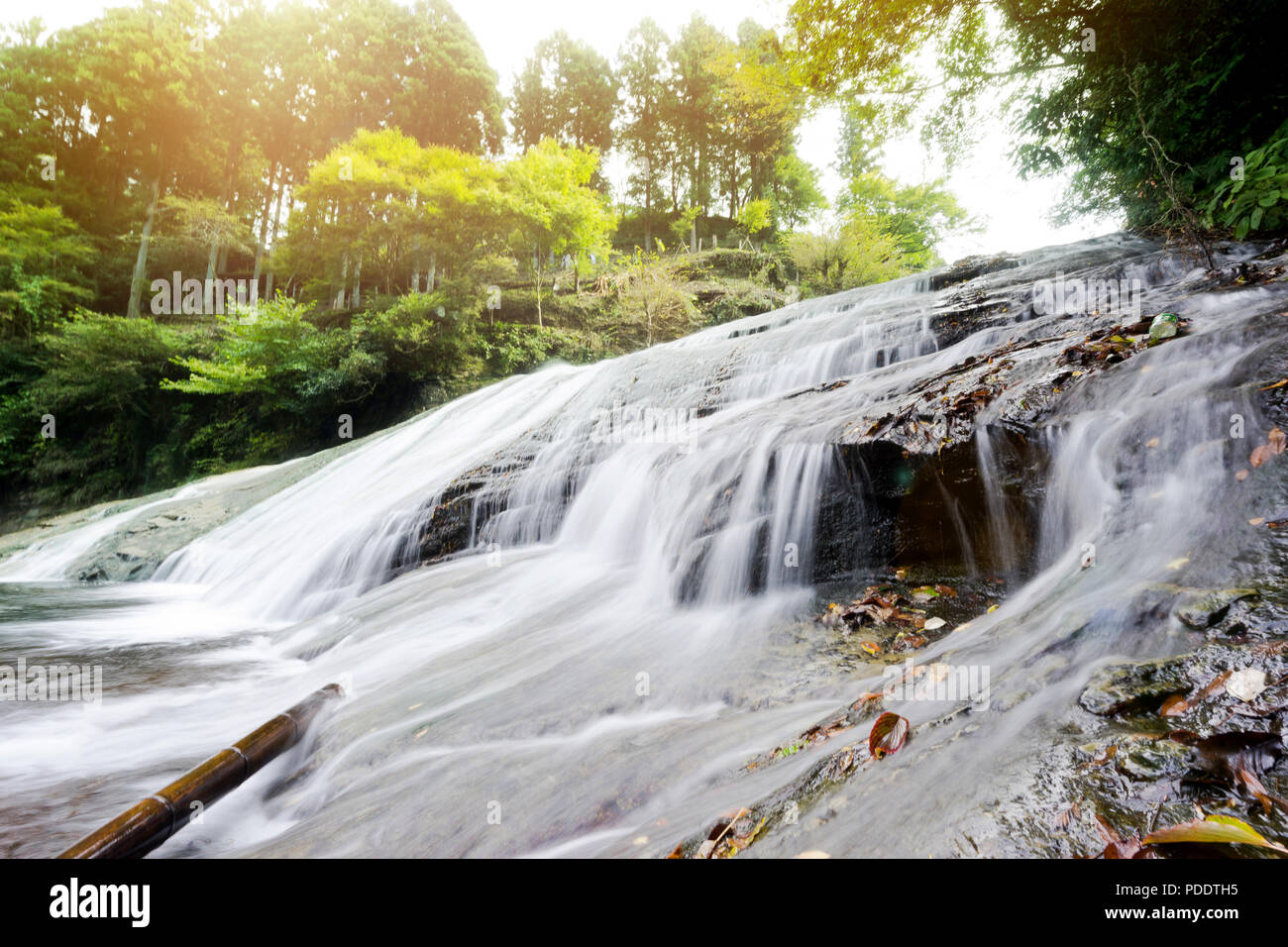 Japan travel concept - beautiful yoro keikoku valley waterfall under dramatic sun glow and morning blue sky in Chiba Prefecture, Japan Stock Photo