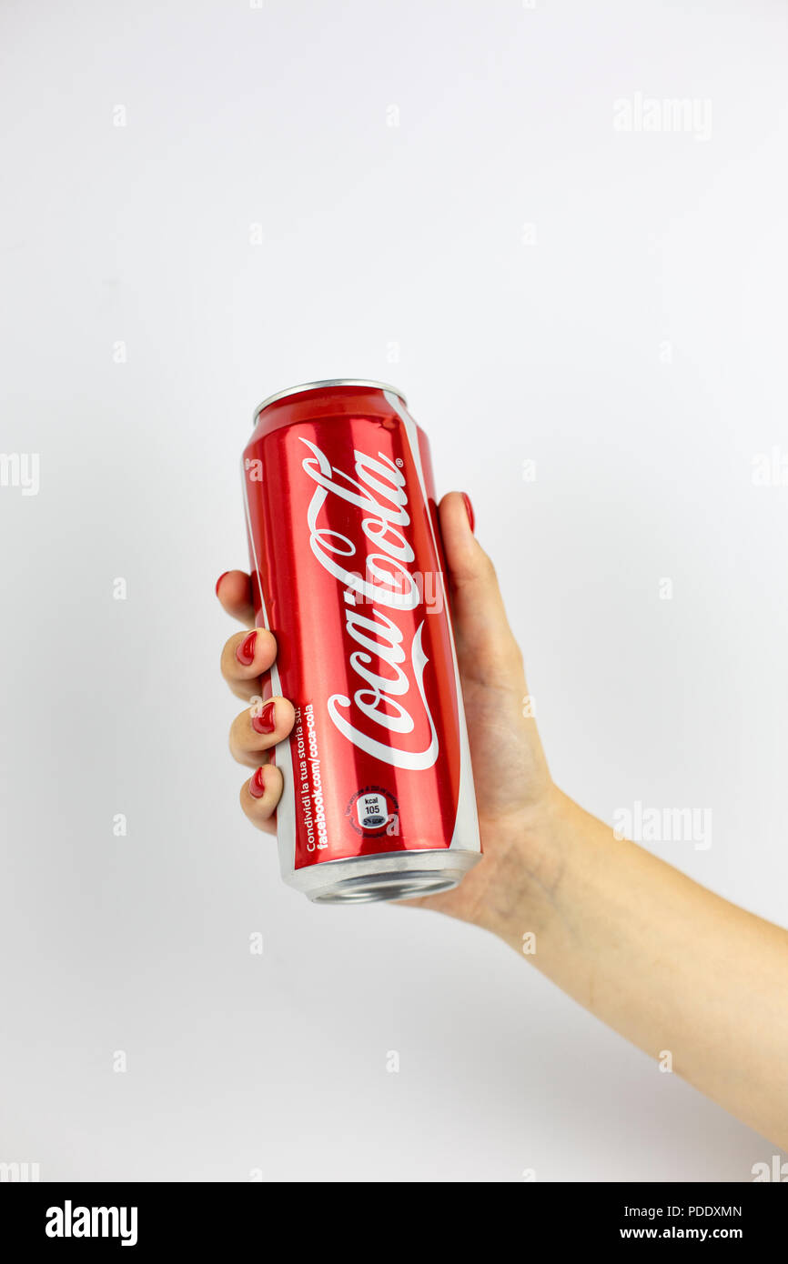 Atlanta, Georgia, USA - July 22, 2018: woman hand with red nails holding aluminum can coca-cola classic from with white painted logo from USA on white background Stock Photo