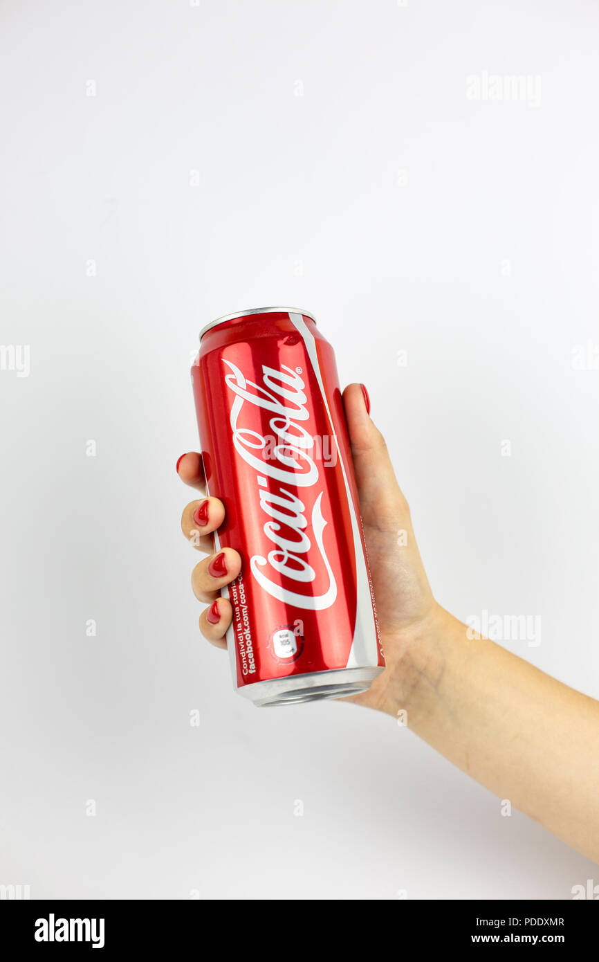 Atlanta, Georgia, USA - July 22, 2018: woman hand with red nails holding huge aluminum can coca-cola classic from USA on white background Stock Photo