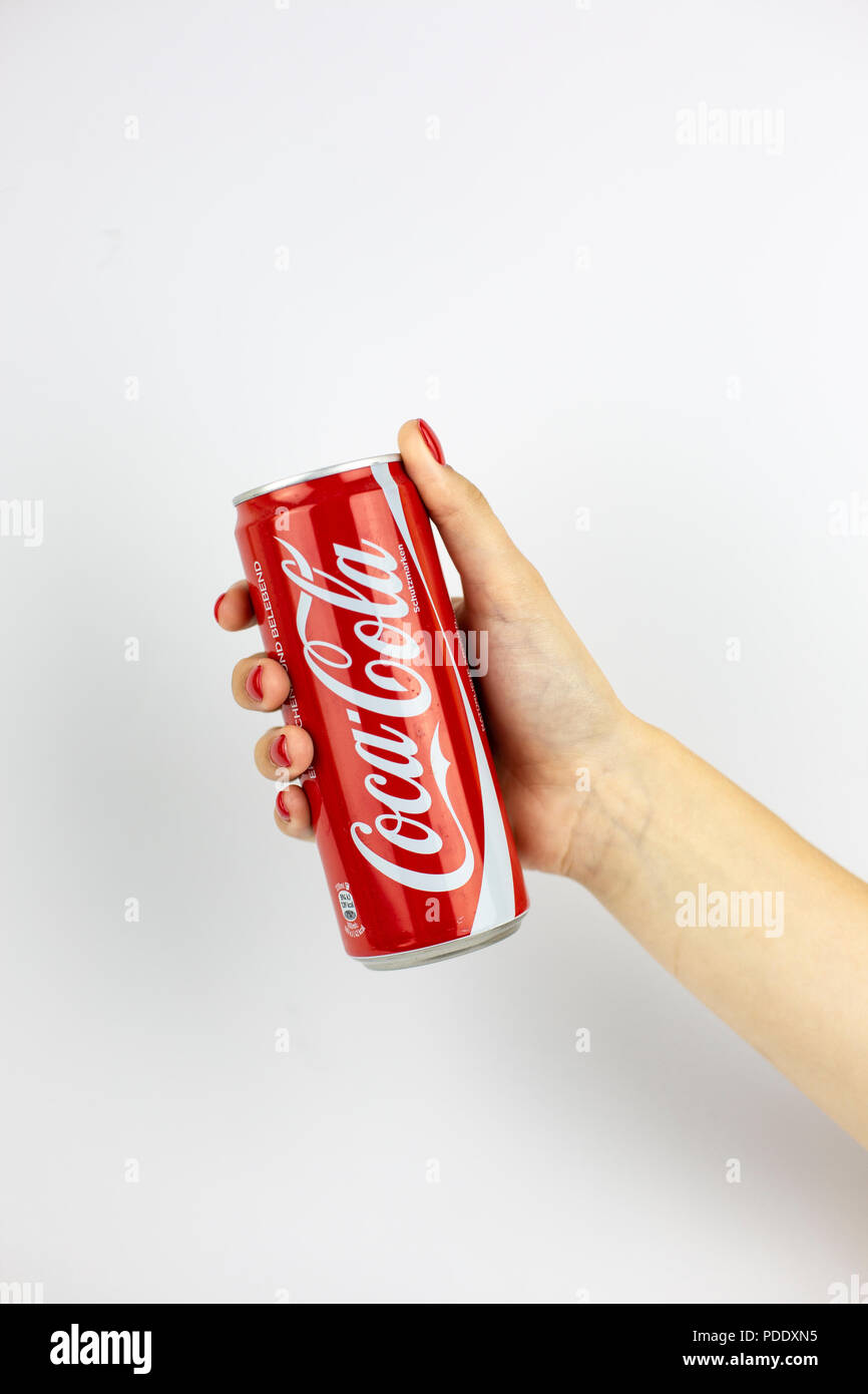 Atlanta, Georgia, USA - July 22, 2018: woman hand with red nails holding huge aluminum can coca-cola classic from USA isolated on white background Stock Photo