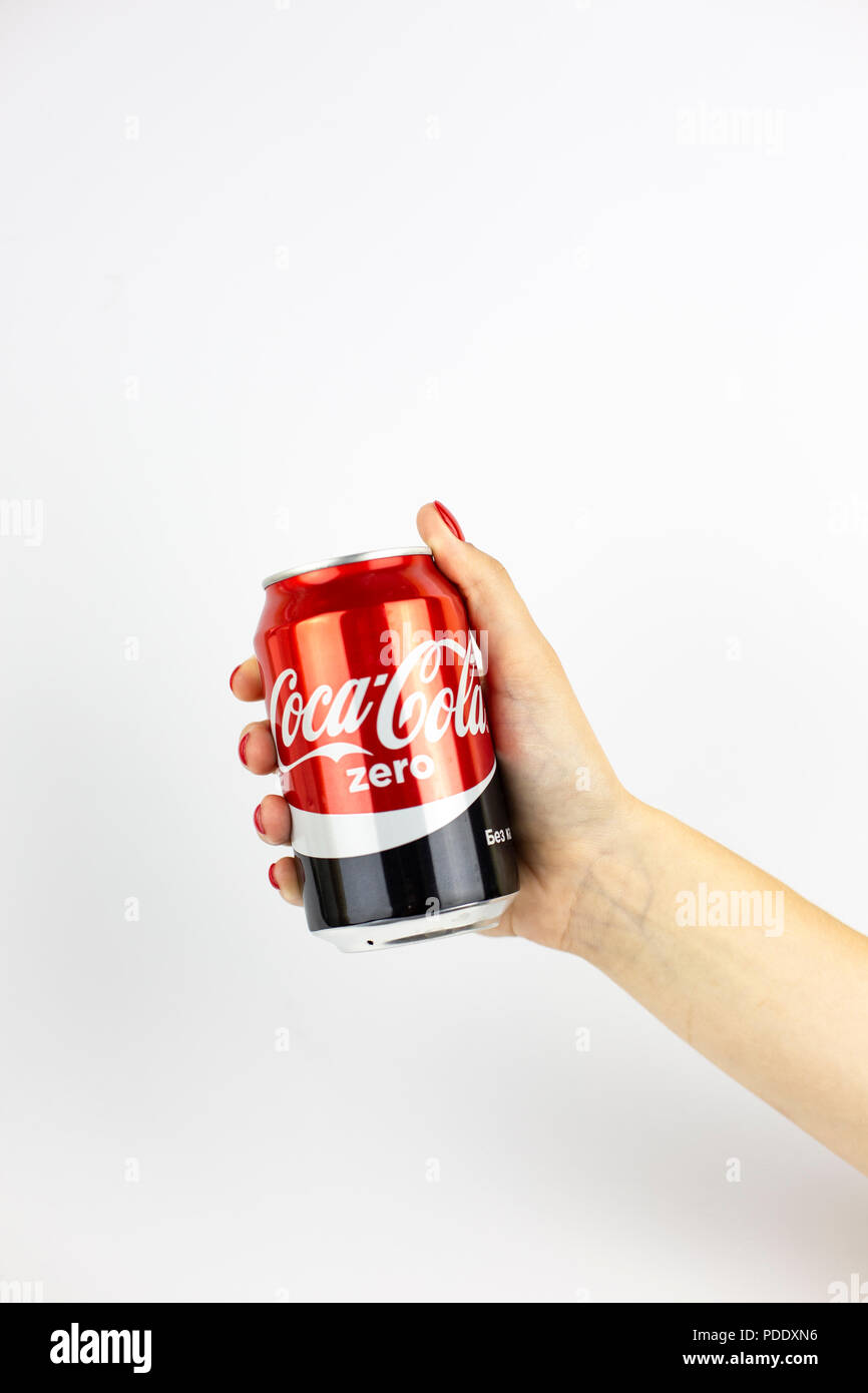 Atlanta, Georgia, USA - July 22, 2018: woman hand with red nails holding huge aluminum can coca-cola zero from Russia on white background Stock Photo