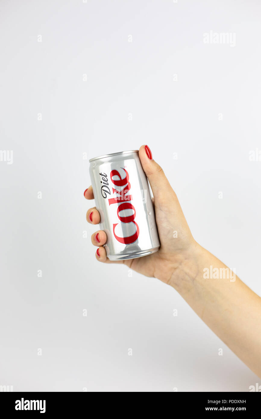 Atlanta, Georgia, USA - July 22, 2018: woman hand with red nails holding silver aluminum can coca-cola Diet Coke from USA on white background Stock Photo