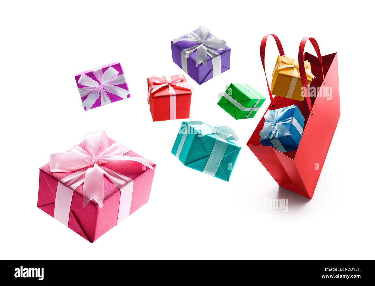 Gift boxes pop out from red shopping bag isolated on white background Stock Photo