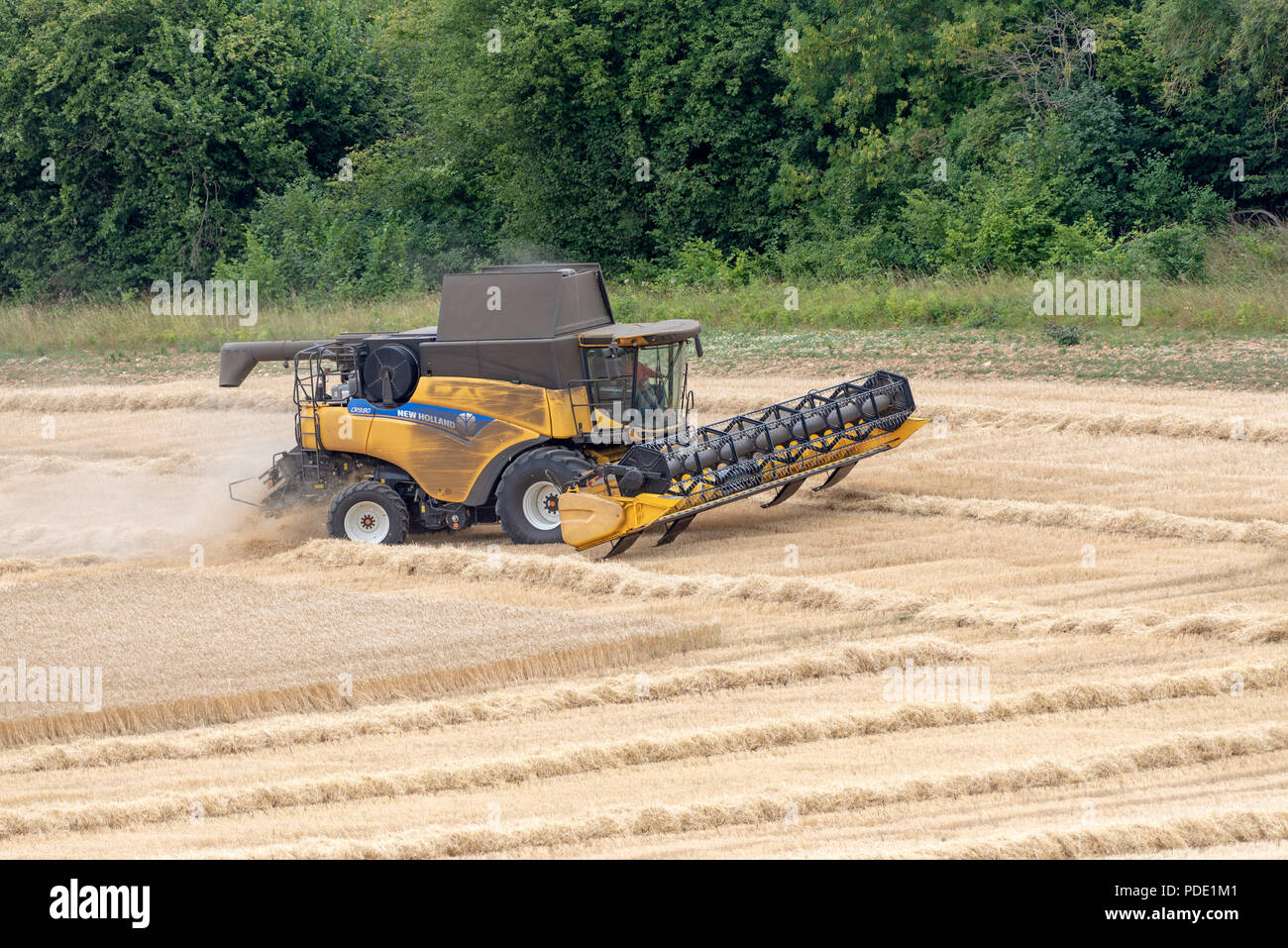 Combine harvester at work on farmland at harvest time in Hampshire