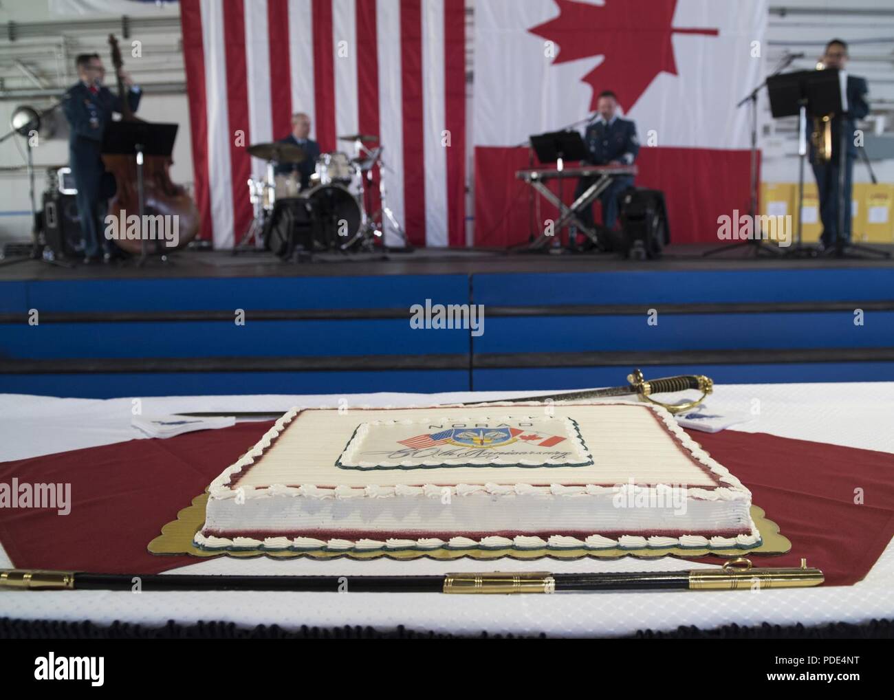 A celebratory cake is displayed during the North American Aerospace Defense Command's 60th Anniversary Ceremony on Peterson Air Force Base Colorado, May 12, 2018. The ceremony and static display of various NORAD aircraft was the culmination of a three-day event, which included a media tour of Cheyenne Mountain Air Force Station, the dedication of a cairn outside the commands' headquarters building memorializing the Canadians who have passed away while serving NORAD, and a fly over in missing-man formation performed by the Royal Canadian Air Force's Snowbirds aerial demonstration team. Stock Photo