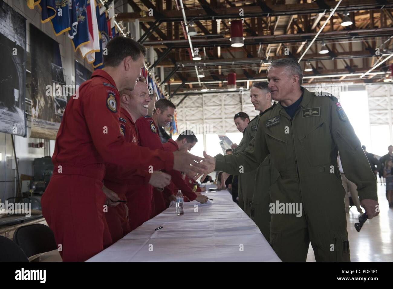 Members of the Royal Canadian Air Force’s Snowbirds aerial demonstration team greet guests at the North American Aerospace Defense Command's 60th Anniversary Ceremony on Peterson Air Force Base Colorado, May 12, 2018. The ceremony and static display of various NORAD aircraft was the culmination of a three-day event, which included a media tour of Cheyenne Mountain Air Force Station, the dedication of a cairn outside the commands' headquarters building memorializing the Canadians who have passed away while serving NORAD, and a fly over in missing-man formation performed by the Royal Canadian Ai Stock Photo