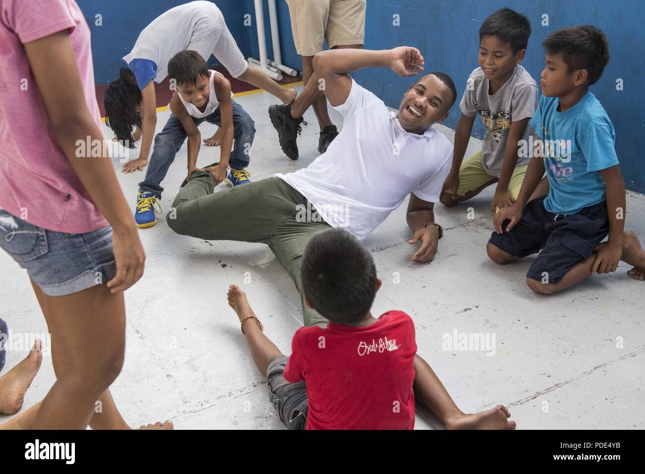 U.S. Marine Corps Lance Cpl. Rashad Howard, native of Los Angeles, assigned to Disbursing Office, Alpha Company, 3rd Marine Logistics Group, break dances for the children at the Gentle Hands Child Care Center, Quezon City, Philippines. Gentle Hands is a child and youth welfare agency that provide rescue and rehabilitation for medical, social, psychological, and educational needs of at-risk children and youth, and advocating for the rights of the children. Philippine, U.S., Australian, and Japanese service members spent Mother’s Day volunteering at the center as part of a community relations ef Stock Photo