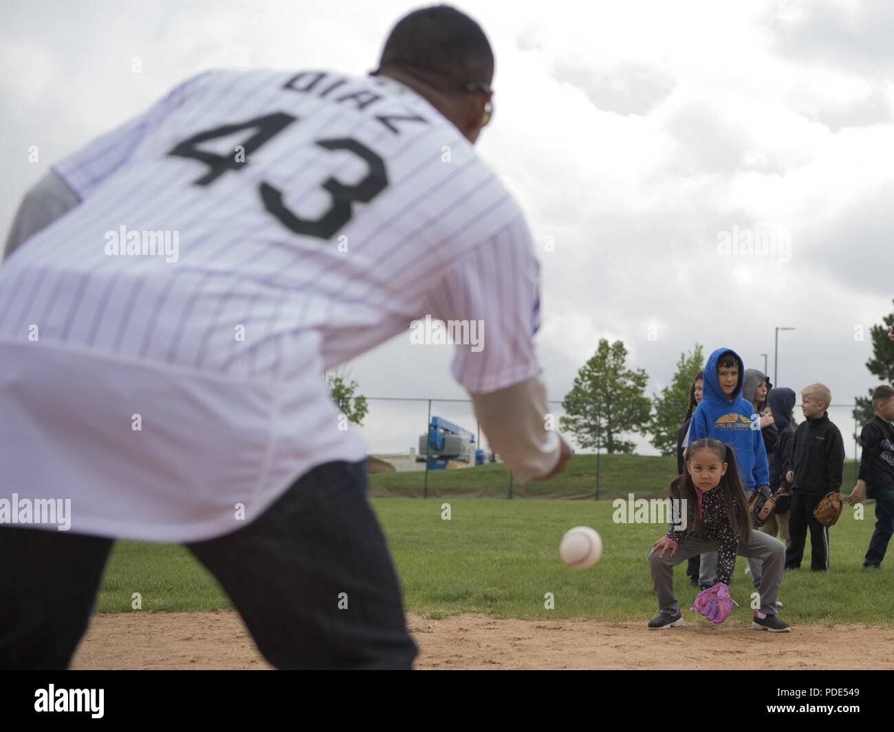Tony Diaz, Colorado Rockies first base coach, throw grounders to