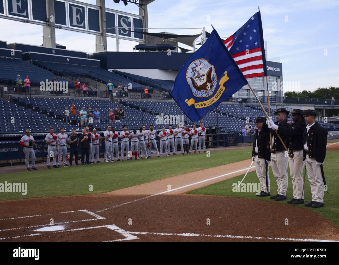 TAMPA, Fla. (May 12, 2018) Sailors assigned to USS Constitution post the  colors at a Tampa Tarpons baseball game during Navy Week Tampa. Tampa is  one of select cities to host a