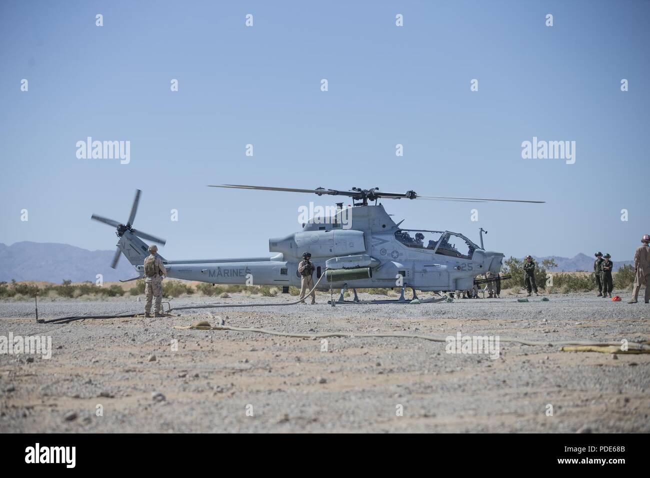 U.S. Marines with Marine Light Attack Helicopter Squadron 367 fuel an AH-1Z Super Cobra during Integrated Training Exercise (ITX) 3-18 aboard Marine Corps Air Ground Combat Center, Twentynine Palms, Calif., May 14, 2018. ITX is a large-scale, combined-arms training exercise intended to produce combat-ready forces capable of operating as an integrated Marine air-ground task force. Stock Photo