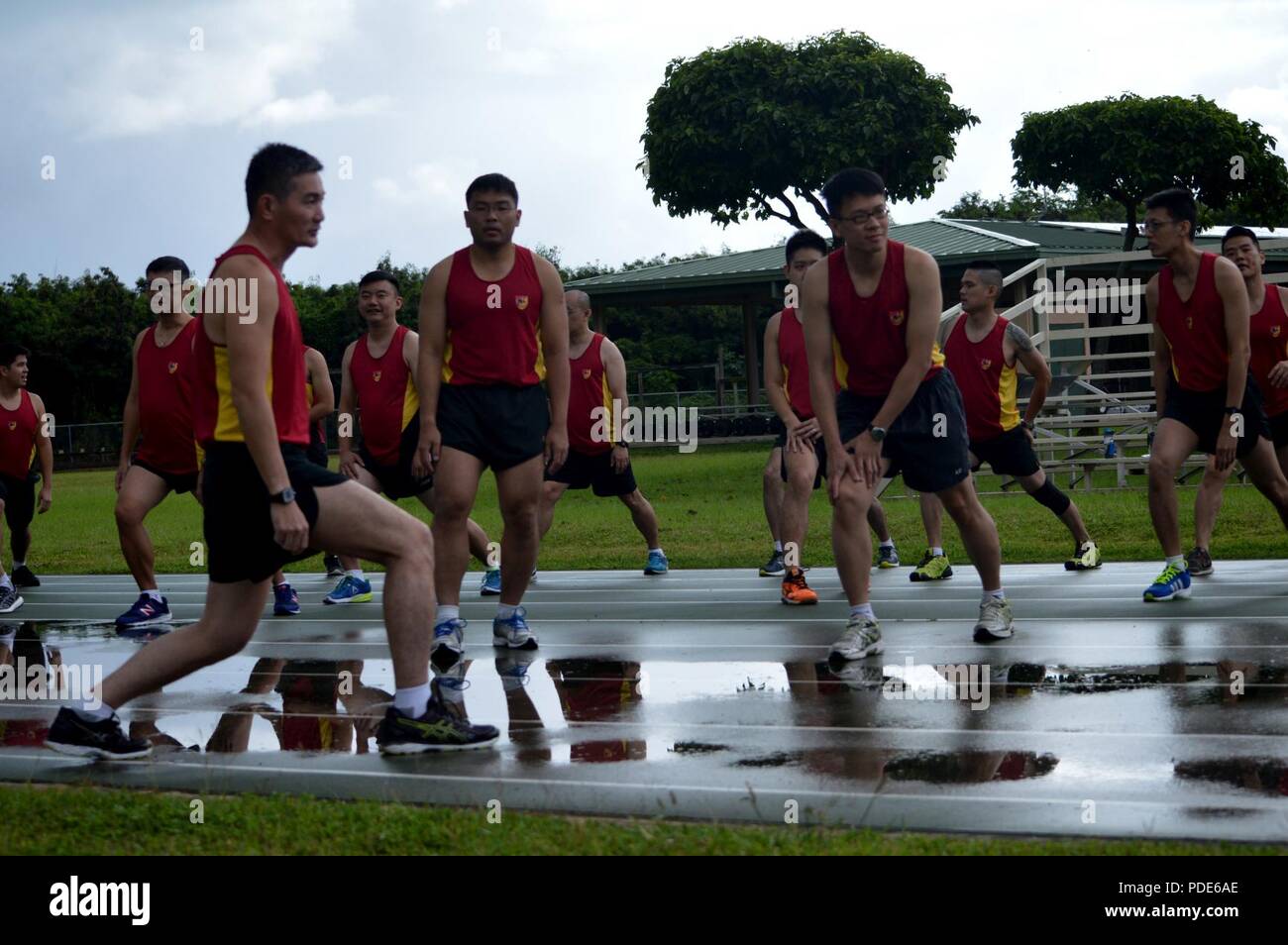 Singapore Army Soldiers stretch as a group prior to the start of the
