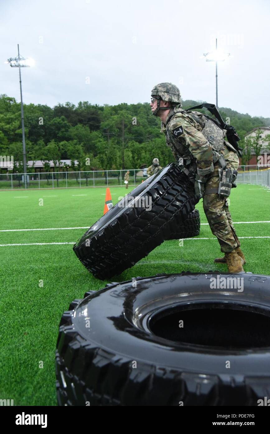 2nd Lt. Brian Trabun, a native of Seattle, WA, assigned to 35th Air Defense Artillery Brigade, flips a tire during the physical fitness challenge during the Eighth Army 2018 Best Warrior Competition, held at Camp Casey, Republic of Korea, May 17. The Eighth Army BWC is being held to recognize and select the most qualified junior enlisted and non-commissioned officer to represent Eighth Army at the U.S. Army Pacific Best Warrior Competition at Schofield Barracks, HI, in June. The competition will also recognize the top performing officer, warrant officer and Korean Augmentation to the U.S. Army Stock Photo