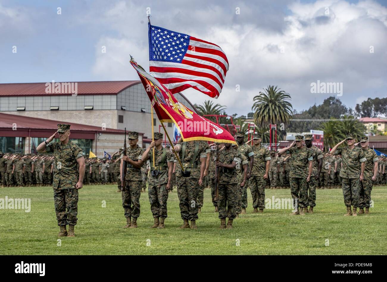 Sgt. Maj. Bradley Kasal, the outgoing I Marine Expeditionary Force sergeant major, salutes during the playing of the national anthem during a relief and appointment ceremony on Camp Pendleton, Calif., May 18, 2018. Sgt. Maj. James Porterfield replaced Kasal as I MEF sergeant major. Kasal has served as I MEF sergeant major since 2015 and is retiring from the Marine Corps after 34 years of service. Stock Photo