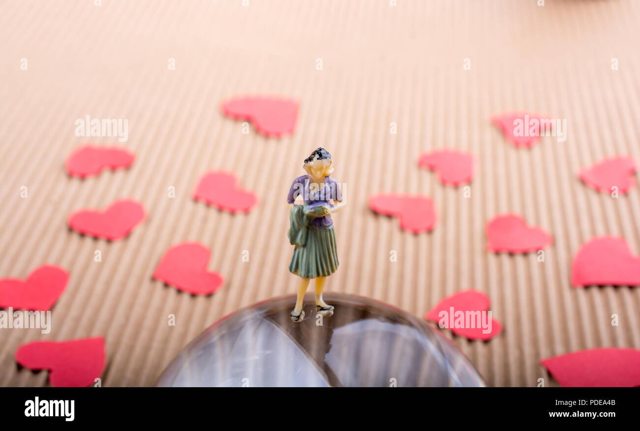 Woman figurine and Love concept with red paper hearts Stock Photo - Alamy