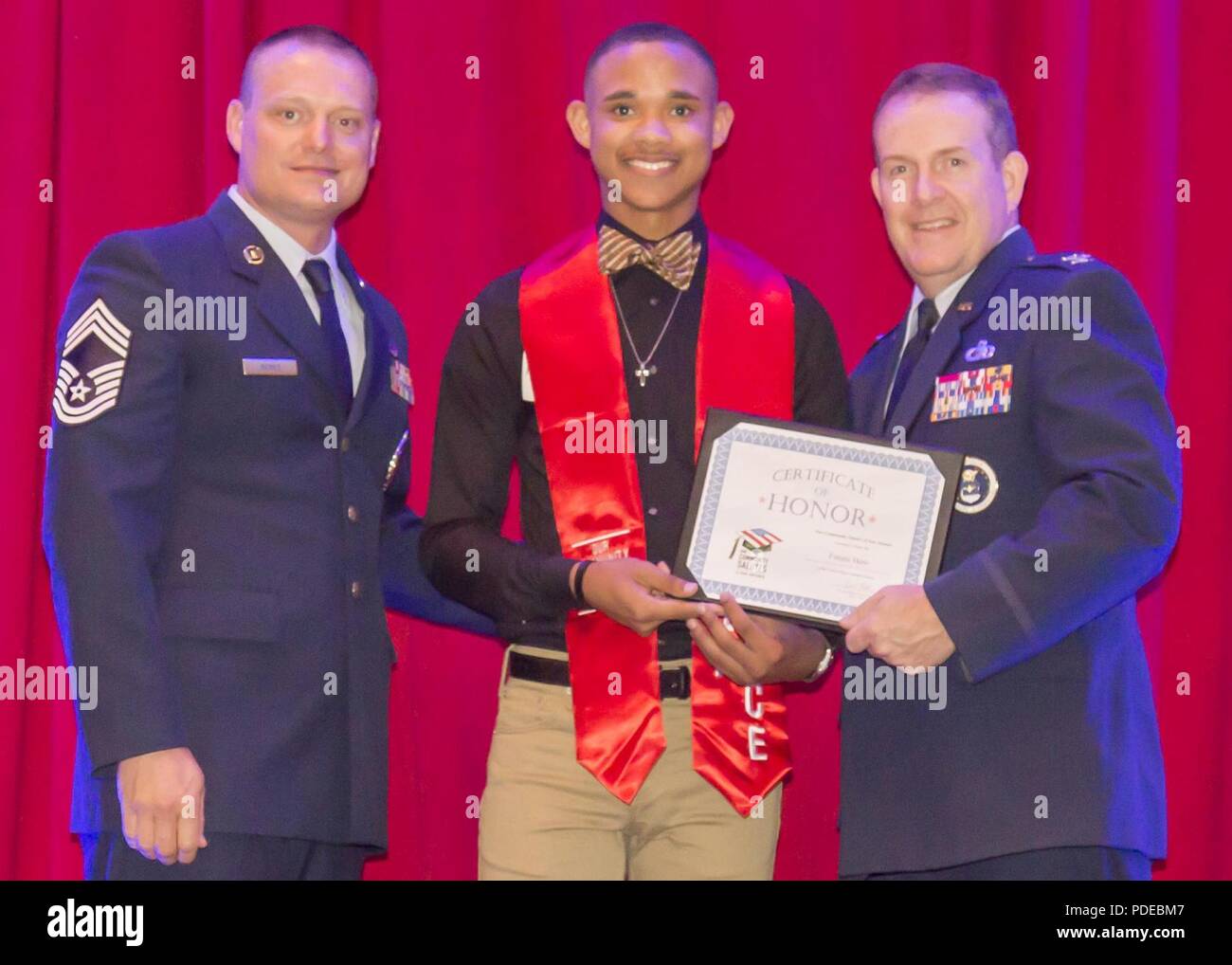 SAN ANTONIO – (May 16, 2018) Air Force Col. Sean McKenna, chief of Plans and Resources Division, Headquarters Air Force Recruiting Service, and Chief Master Sgt. William Rawls pose with a future Airman, who was honored during “A Night in Your Honor” hosted by Our Community Salutes-San Antonio (OCS) held in the Rosenberg Sky Room at the University of the Incarnate Word.  Each honoree received an OCS certificate and challenge coin from USAA. OCS is a non-profit organization created in 2009 by Dr. Kenneth E. Hartman to recognize and honor local graduating high school seniors who plan to enlist in Stock Photo
