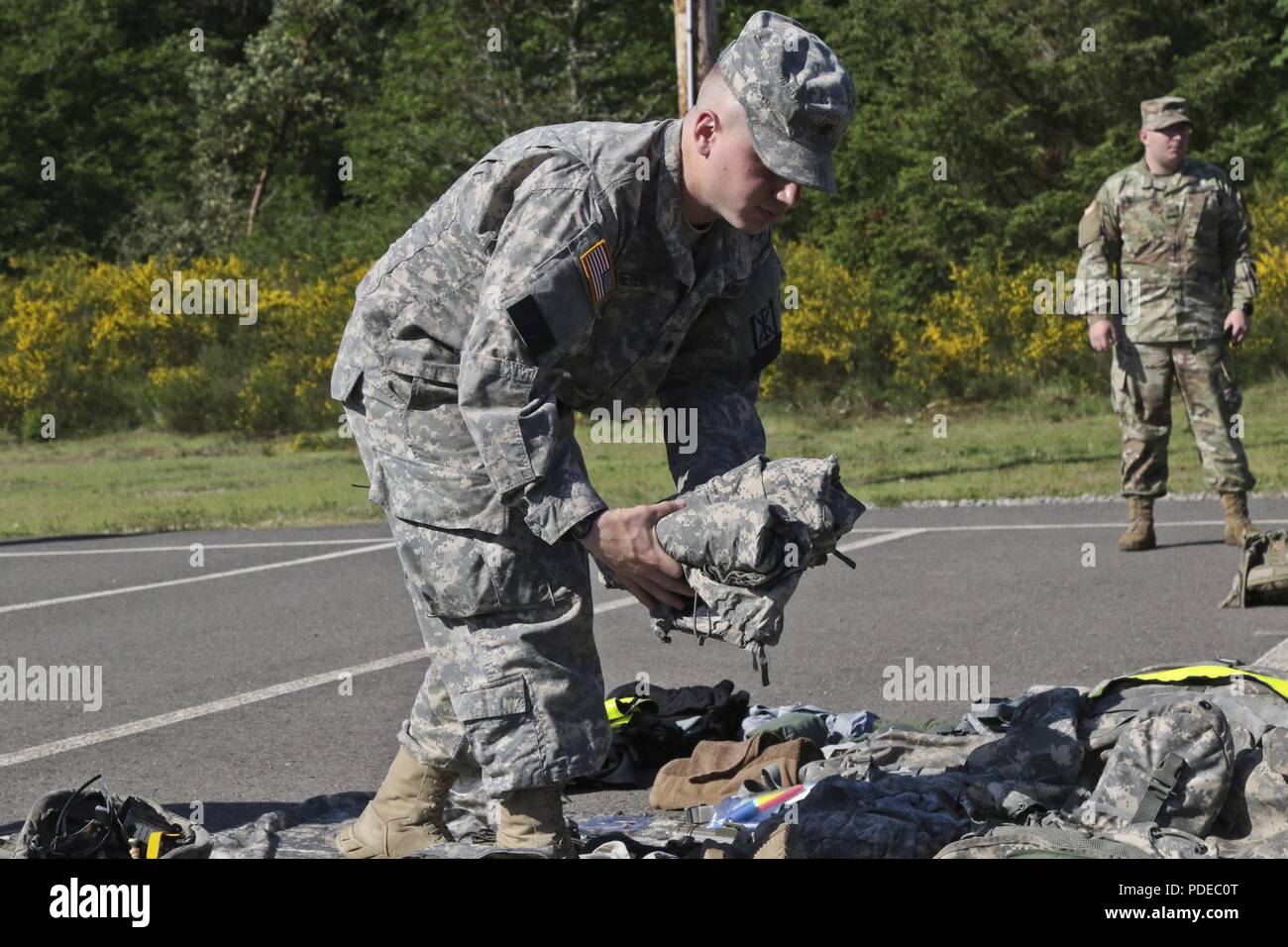 Spc. Jakob Bierer from Headquarters Support Company, 308th Brigade Support Battalion, 17th Field Artillery Brigade and a native of Arlington, Wash., gathers items to show for the TA-50 layout inventory for the 2nd Annual I Corps Best Warrior Competition at Joint Base Lewis-McChord, May 14, 2018. The BWC is held to measure soldier’s technical and tactical abilities while competing in a high stress situation. Stock Photo