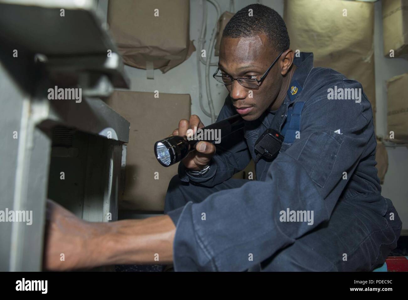 MEDITERRANEAN SEA (May 19, 2018) Chief Damage Controlman Damarcus McCoy inspects an Aqueous Film Forming Foam (AFFF) station aboard the Nimitz-class aircraft carrier USS Harry S. Truman (CVN 75). As the Carrier Strike Group 8 flag ship, Truman's support of Operation Inherent Resolve demonstrates the capability and flexibility of U.S. Naval Forces, and its resolve to eliminate the terrorist group ISIS and the threat it poses. Stock Photo