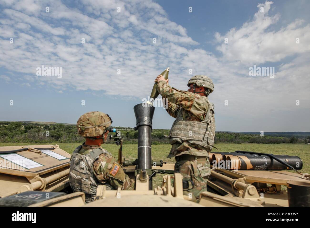 Spc. Tyler Hughes and Pfc. David West, Apache 9-1 crew, 4-9 Cav, 2ABCT load a high explosive (HE)round from their M1064A3 during the brigade's Mortar Training and Evaluation Program (MORTEP) at Curry Mortar Center, Fort Hood May 15. The (MORTEP) is a bi-annual certification program for a mortar troop on organic indirect fire systems. Stock Photo