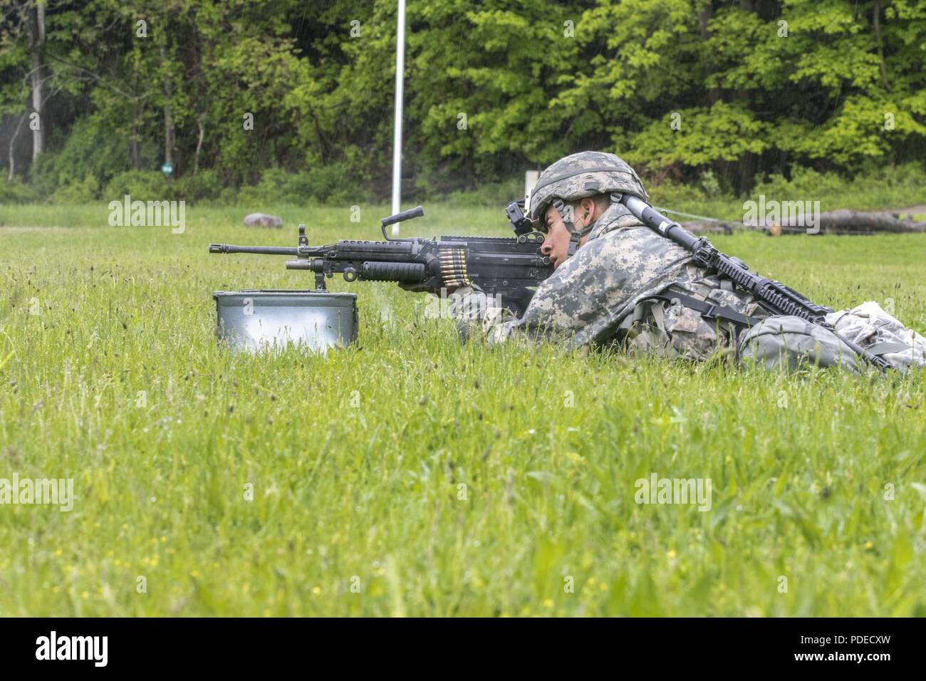 U.S. Army Spc. Saul Hernandez, an infantryman assigned to the 3rd Battalion 172nd Infantry Regiment (Mountain), 86th Infantry Brigade Combat Team (Mountain), Maine Army National Guard, shoots an M249 Squad automatic rifle, as he competes in the Stress Shoot event of the Region 1 Army National Guard Best Warrior Competition at Camp Smith, N.Y., May 18, 2018. The competition, held May 16-19, 2018, is an annual event in which junior enlisted Soldiers and non-commissioned officers (NCOs) from eight Northeastern states compete in several events intended to test their military skills and knowledge,  Stock Photo