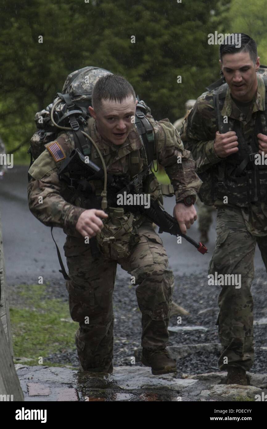 U.S. Army Sgt. Zachary Maynard, a carpentry and masonry specialist assigned to Detachment 2, 1-60th Engineer Company, New Hampshire Army National Guard, completes the 12-mile ruck march portion of the Region 1 Best Warrior Competition at West Point, N.Y., May 19, 2018. The Region 1 Best Warrior Competition, held May 16-19, 2018, is an annual event in which junior enlisted Soldiers and noncommissioned officers (NCOs) from eight Northeastern states compete in several events intended to test their military skills and knowledge, as well as their physical fitness and endurance. The two winners (one Stock Photo