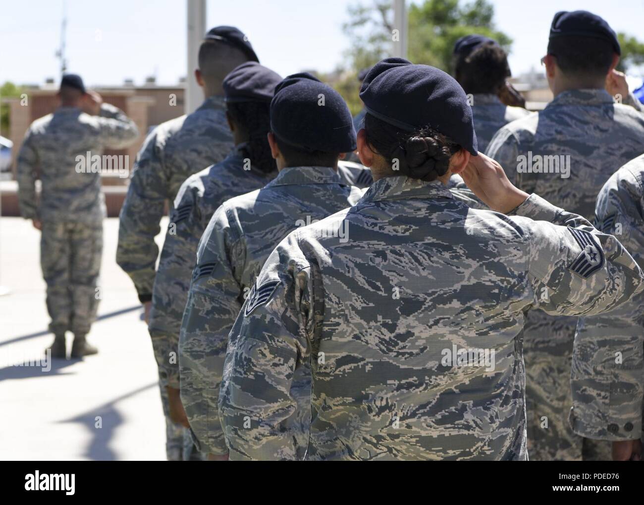 Members of the 49th Security Forces Squadron salute during the playing
