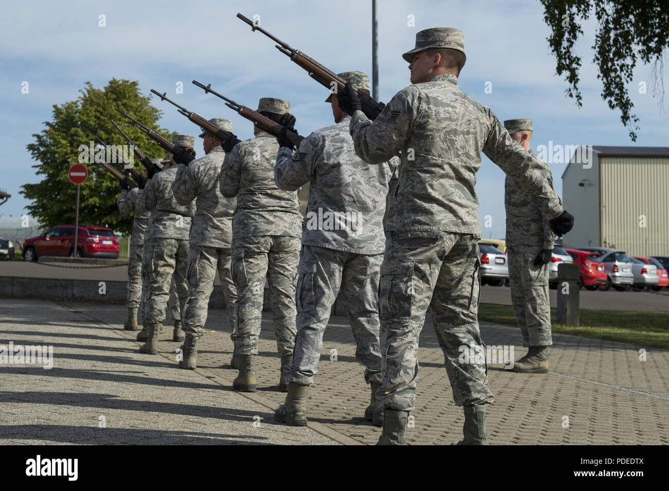 The 52nd Fighter Wing Base Honor Guard conducts a rifle salute during ...