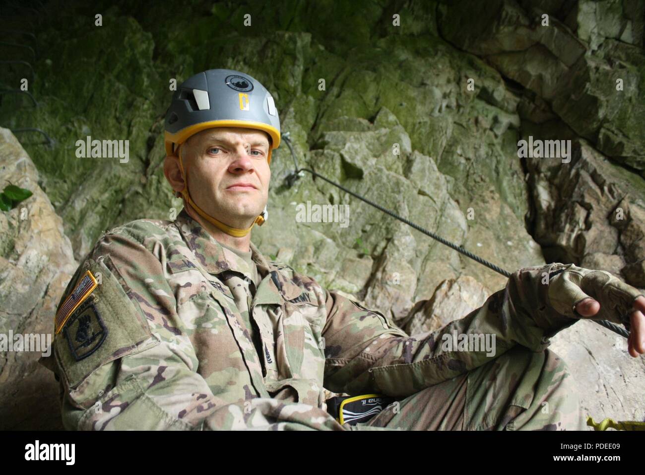 Command Sgt. Maj. Jasan Weaver of the 3-61 CAV waits for the second group of rock climbers at the half-way point up Via Ferrata Berim in Kosovo on May 19. Stock Photo