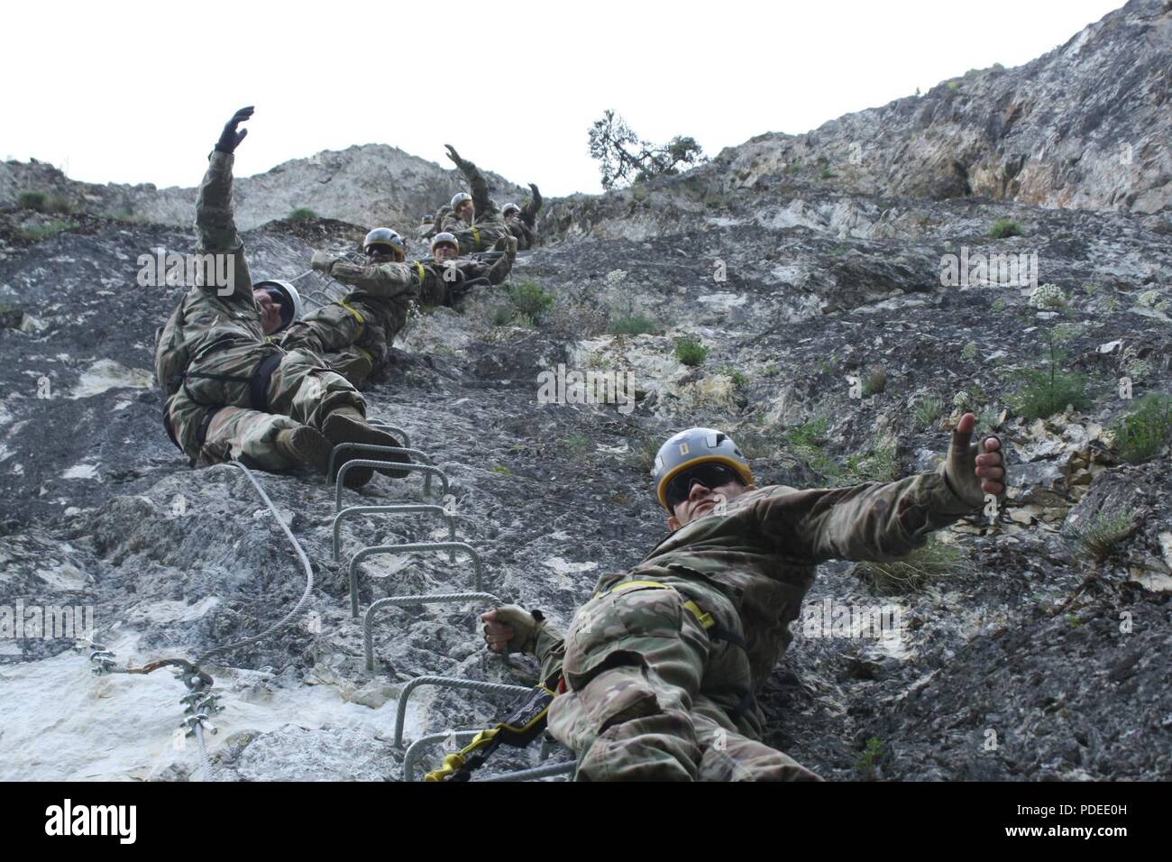 Soldiers stop to pose for a picture while climbing Via Ferrata Berim in Kosovo on May 19. Stock Photo