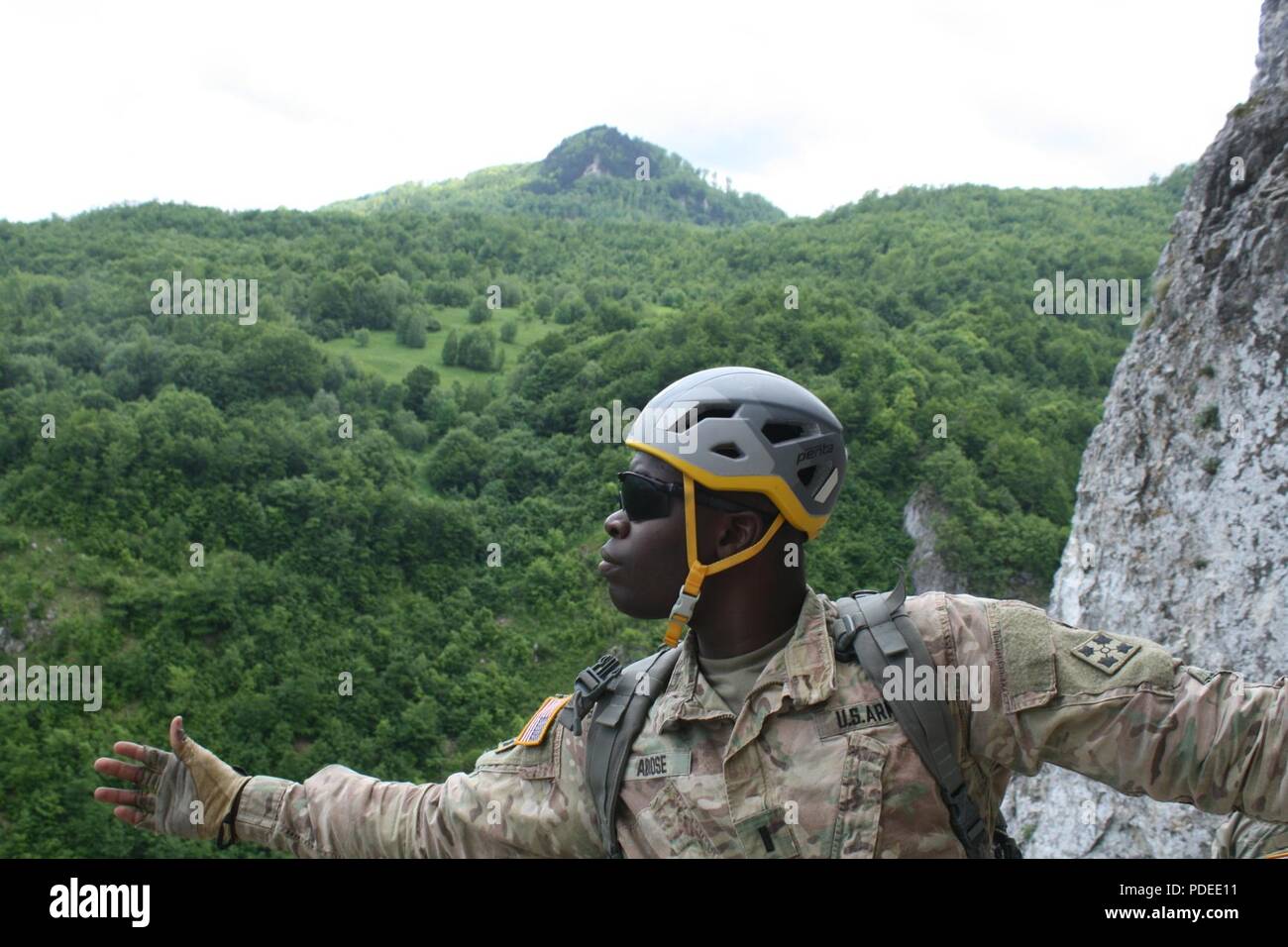 1st Lt. Kareem A. Abiose of the 3-61 CAV takes in the view of his surroundings on Via Ferrata Berim mountain May 19 in Kosovo. This was his first time rock climbing. Stock Photo