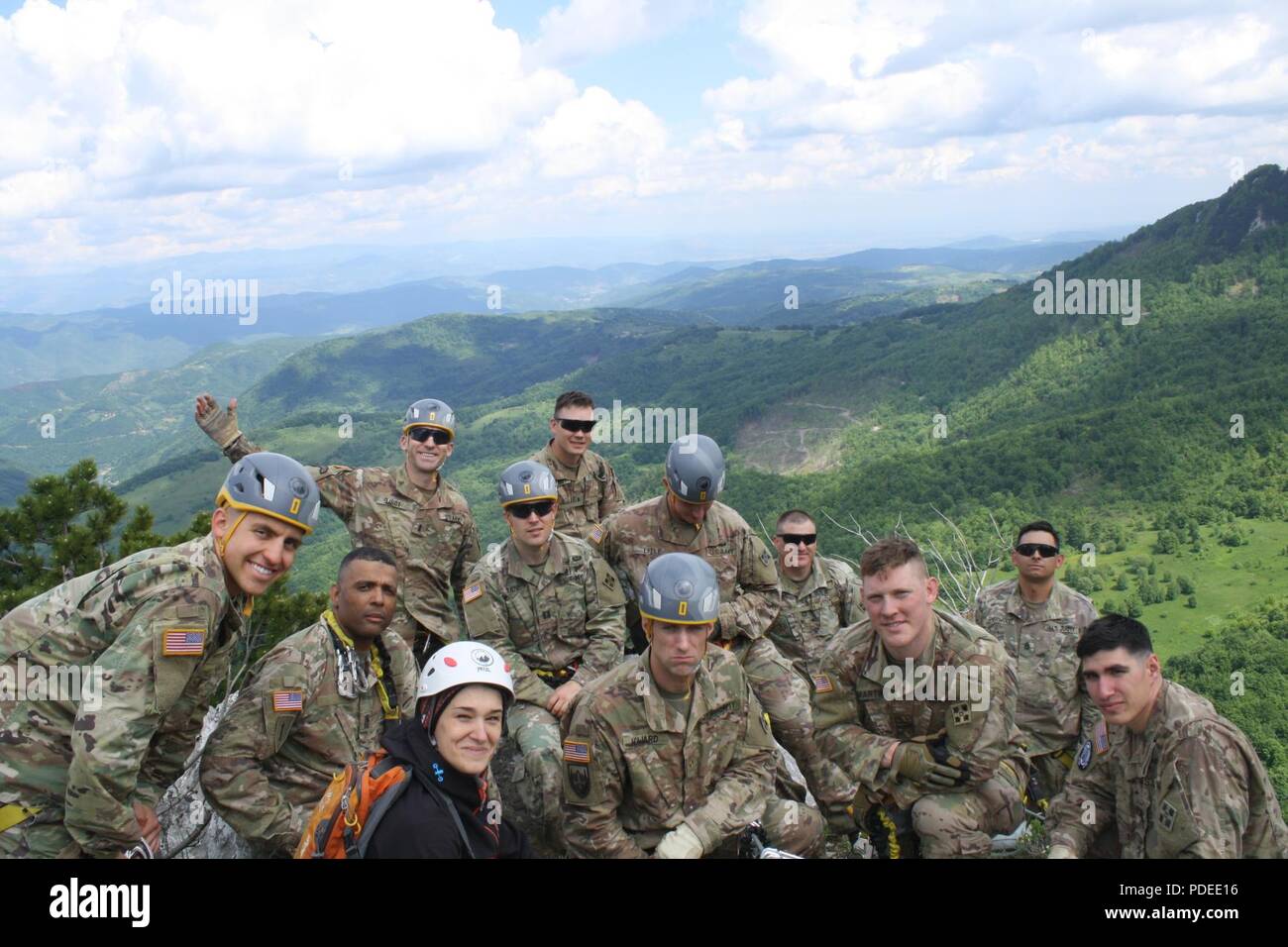 Soldiers from the 3-61 CAV and their climbing guide take in the view atop Via Ferrata Berim mountain May 19 in Kosovo. Stock Photo