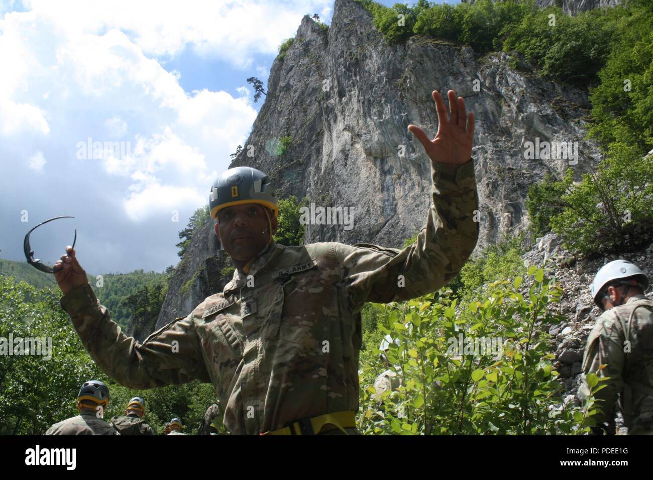 Sgt. Maj Thomas L. Ray, of the 3-61 CAV, climbs Via Ferrata Berim mountain May 19 in Kosovo. Stock Photo