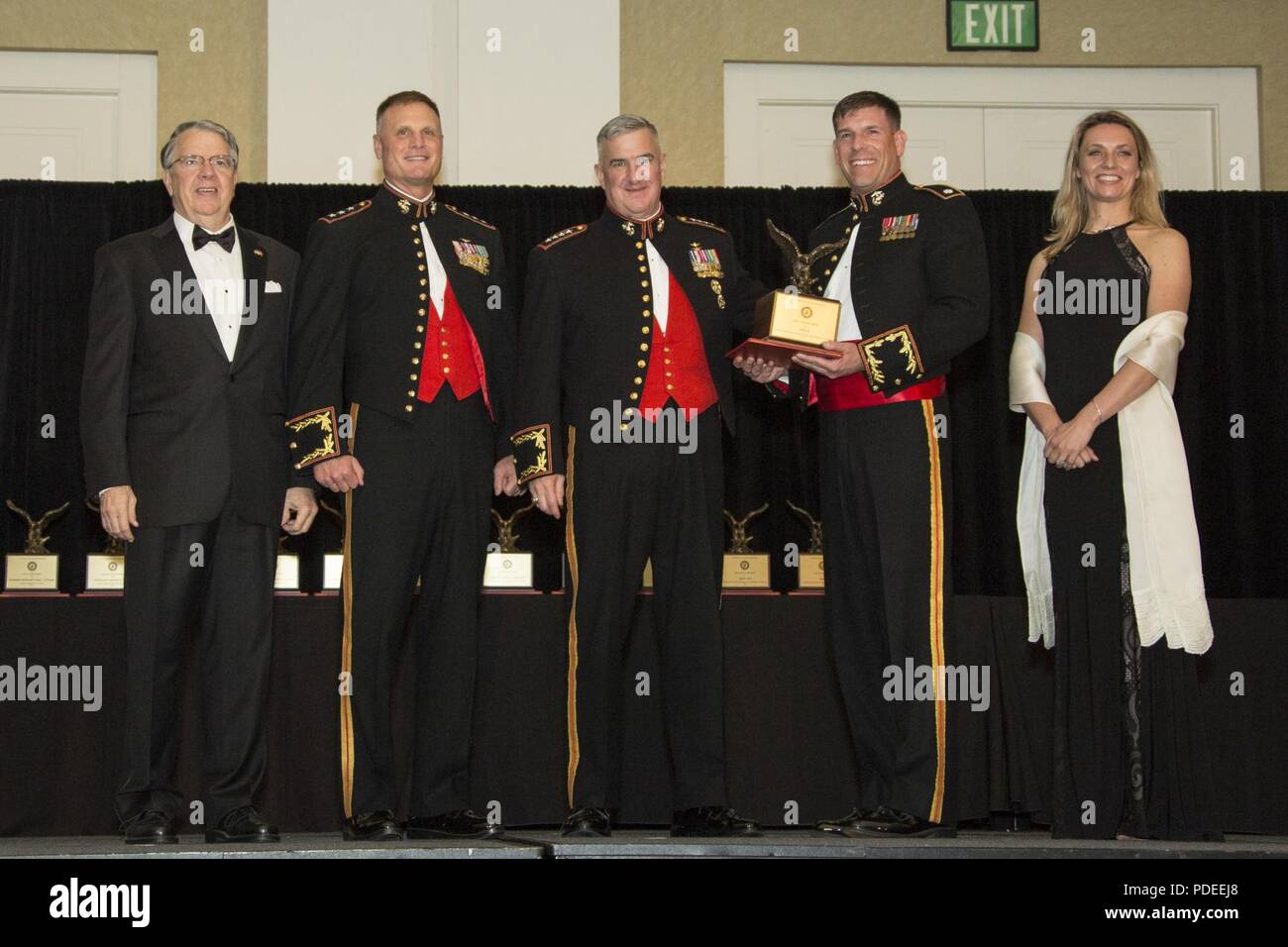 The Assistant Commandant of the Marine Corps Gen. Glenn M. Walters, middle, presents the John I. Hudson Award for Marine Unmanned Aerial Vehicle Squadron of the Year to representatives from Marine Unmanned Aerial Vehicle Squadron 3 (VMU-3), Marine Aircraft Group 24 (MAG-24) during the 47th annual Marine Corps Aviation Association (MCAA) Symposium and Awards Banquet, San Diego, Calif., May 18, 2018. Walters was the guest speaker for the event and presented 13 unit awards and 16 individual awards during the ceremony. Stock Photo